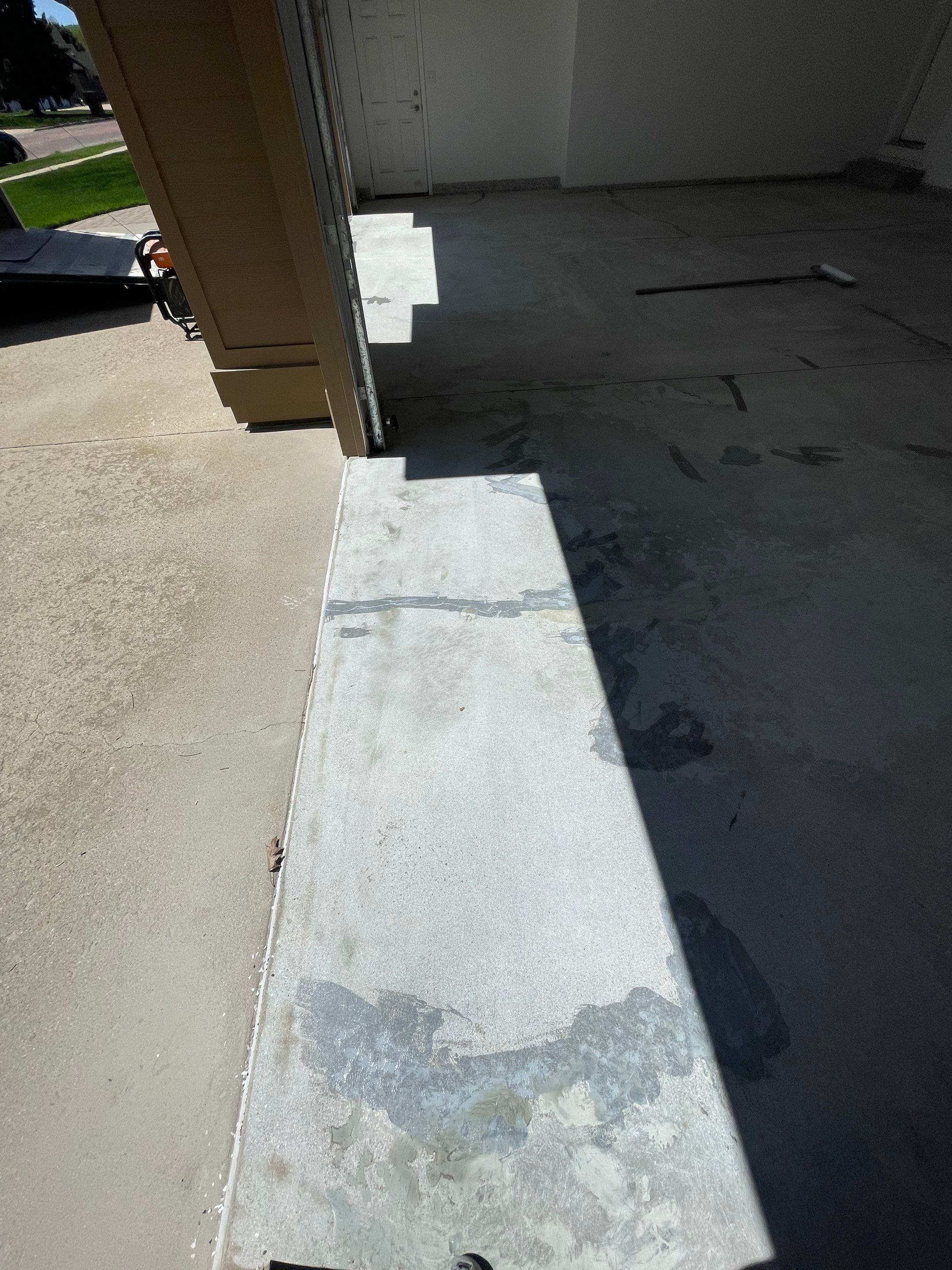 Yankton Garage Floor Restoration with Gray Speckled Epoxy Coating by Select Painting, Coatings & Garage Cabinets