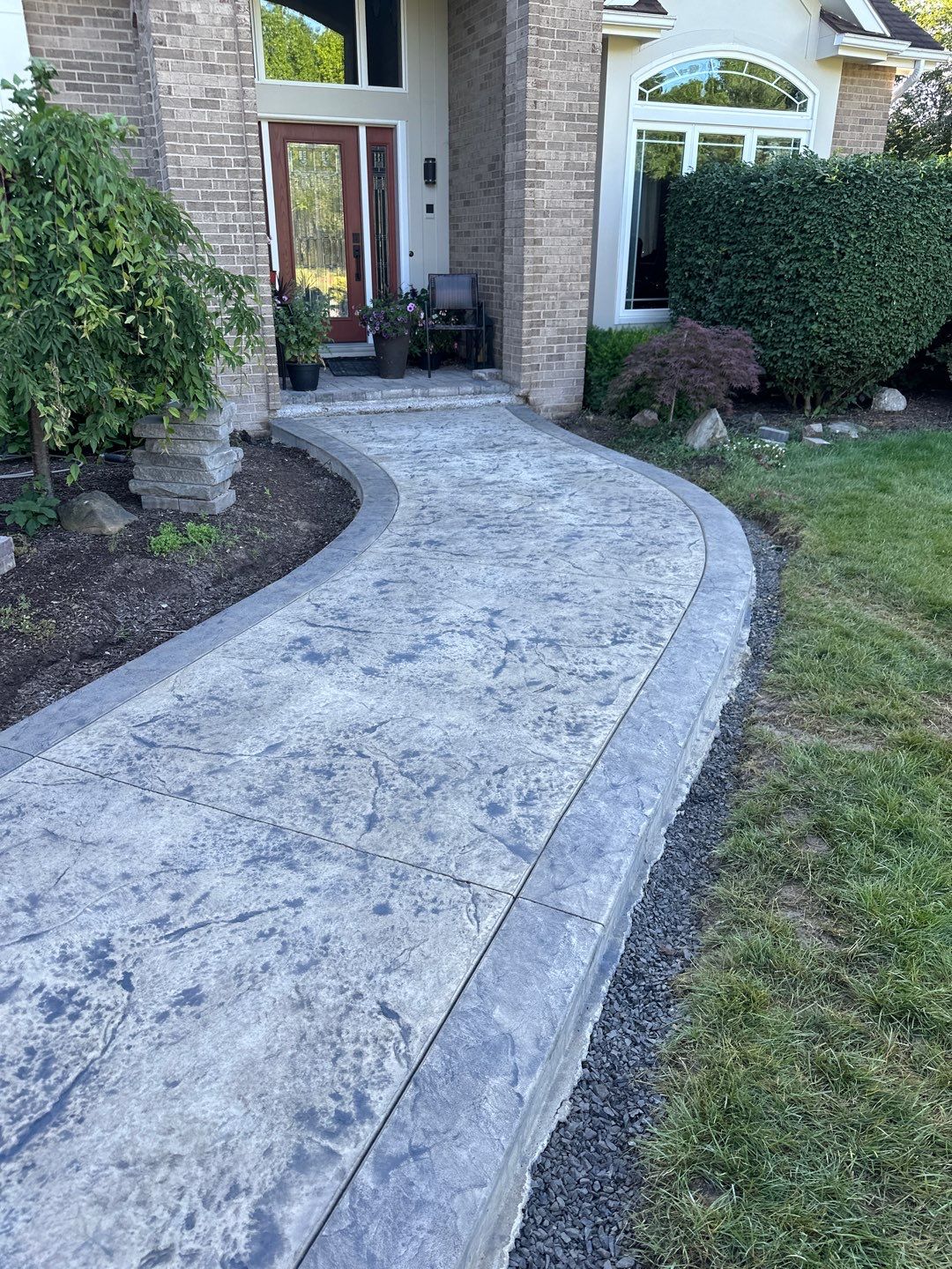 Heavy stone stamped concrete patio and sidewalk  by NG Masonry & Construction LLC