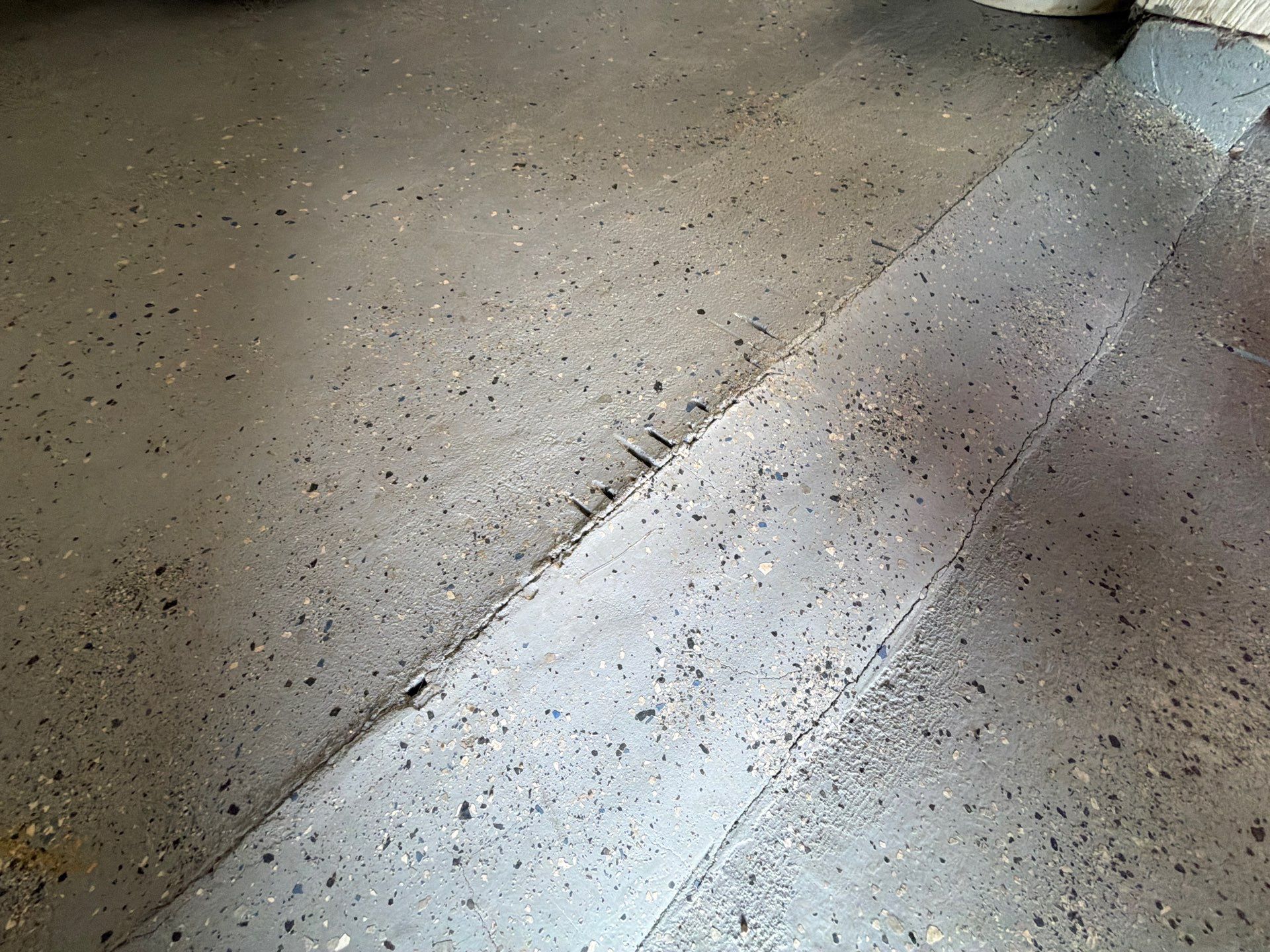 Custom Grey Flake Epoxy Garage Floor Installation in Remsen by Select Painting, Coatings & Garage Cabinets