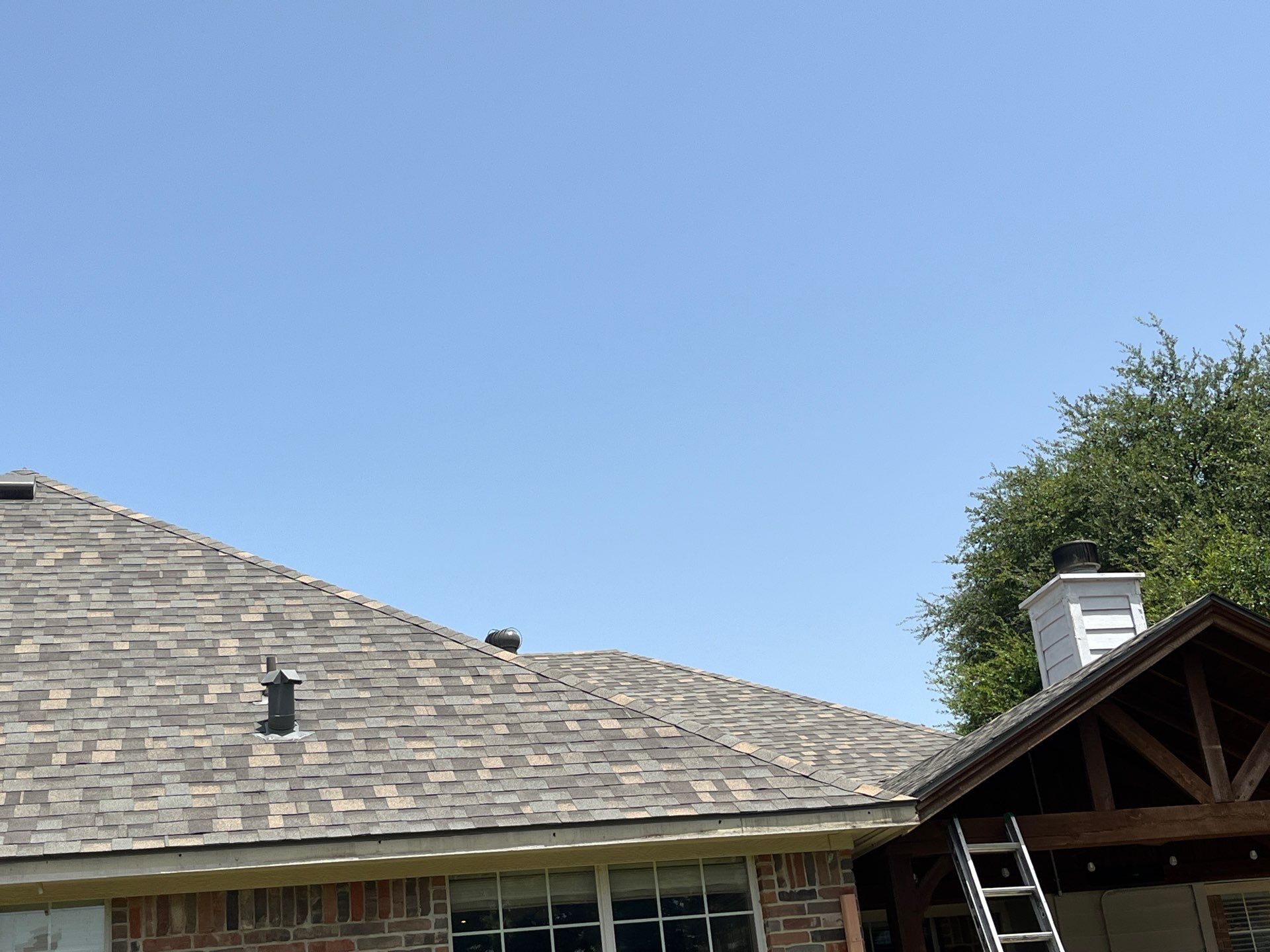 Red brick with IKO Cornerstone  by Tejas Roofworks + Restoration