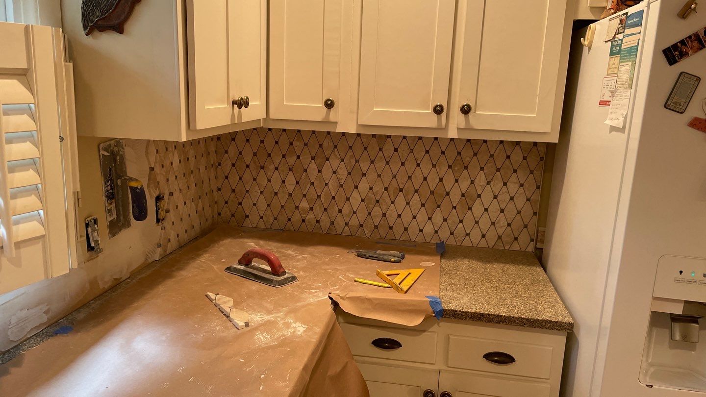 New Backsplash to Compliment the Countertops by Footprints Floors of Coastal Carolina