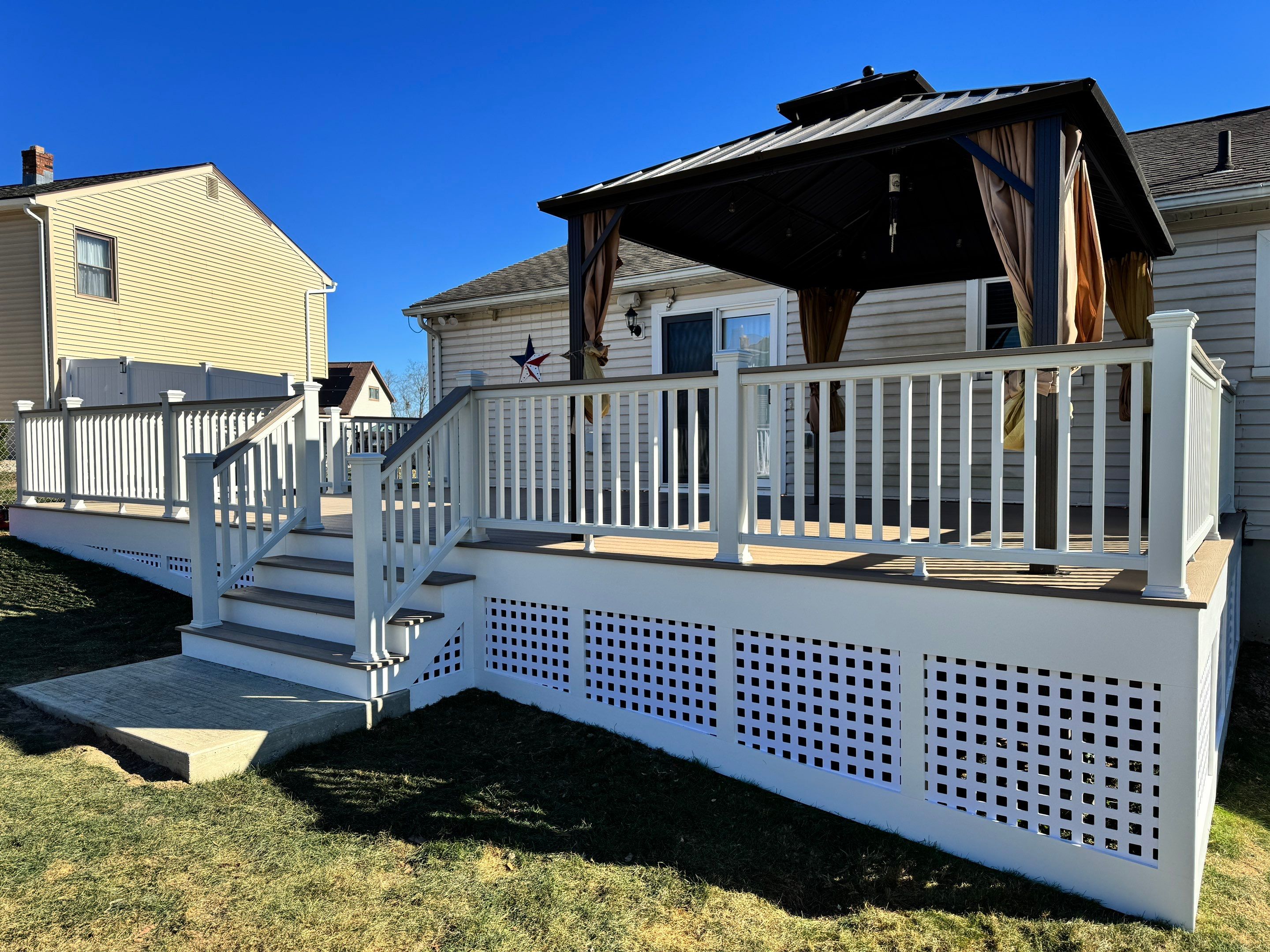 New pool deck and main deck resurface using Trex Transcend Rope Swing boards, White railing and Lattice by DiGiorgi Roofing and Siding Inc