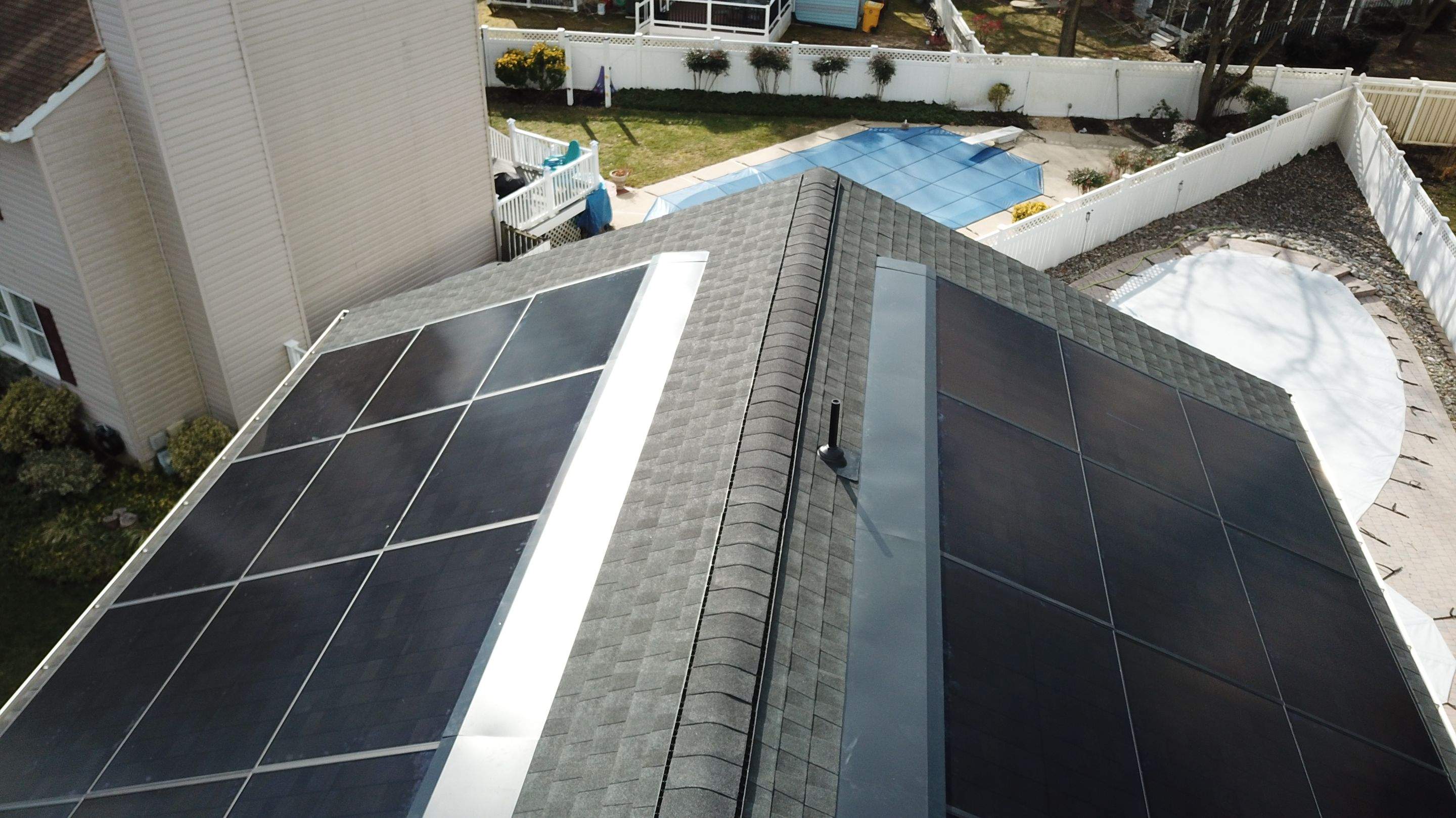 Roof Replacement with GAF Decotech integrated solar panels by American Home Contractors