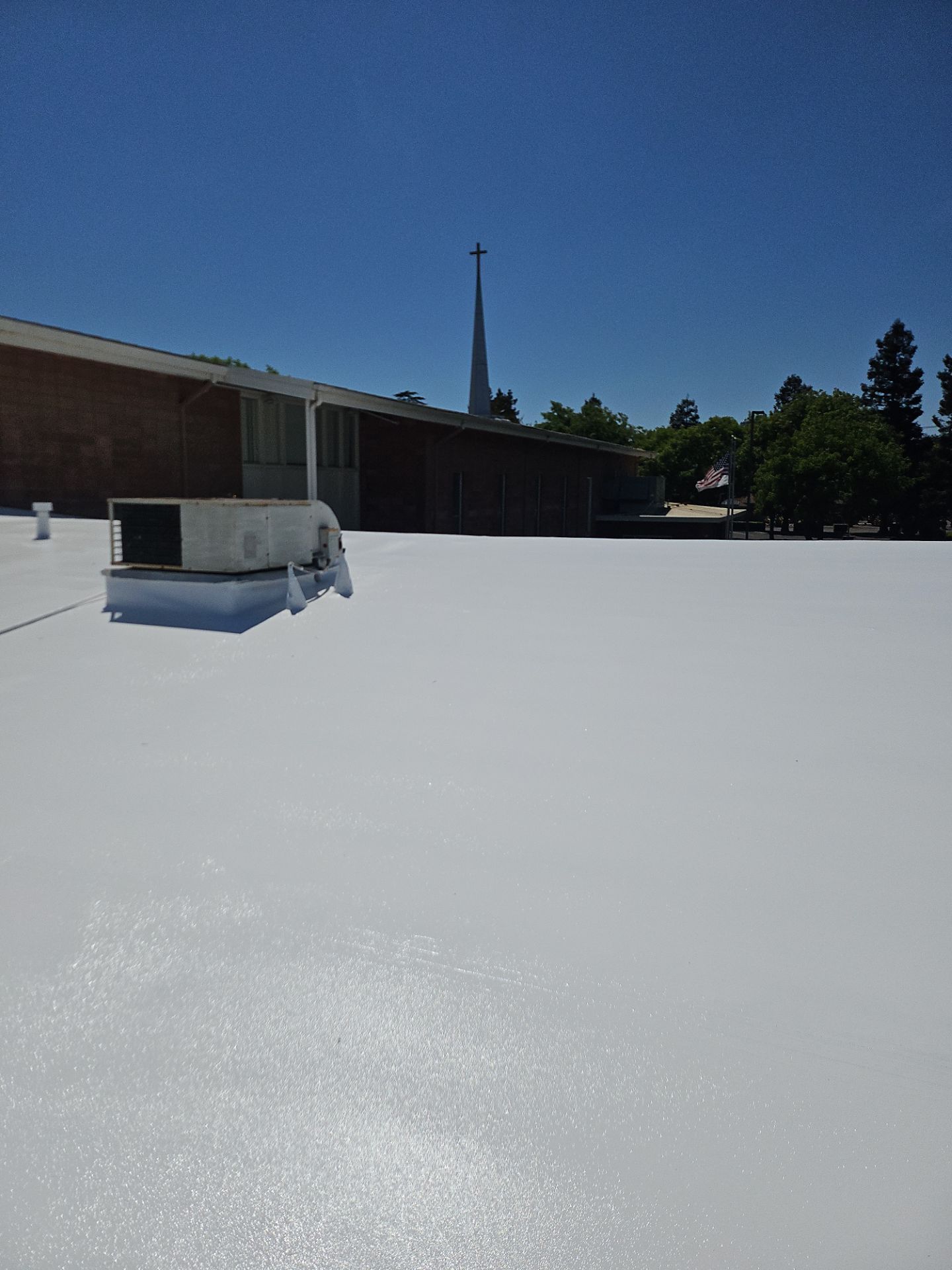 Single-ply restoration system using Benchmark/PUMA XL coatings over TPO single-ply roofing by Straight Edge Roofing Inc