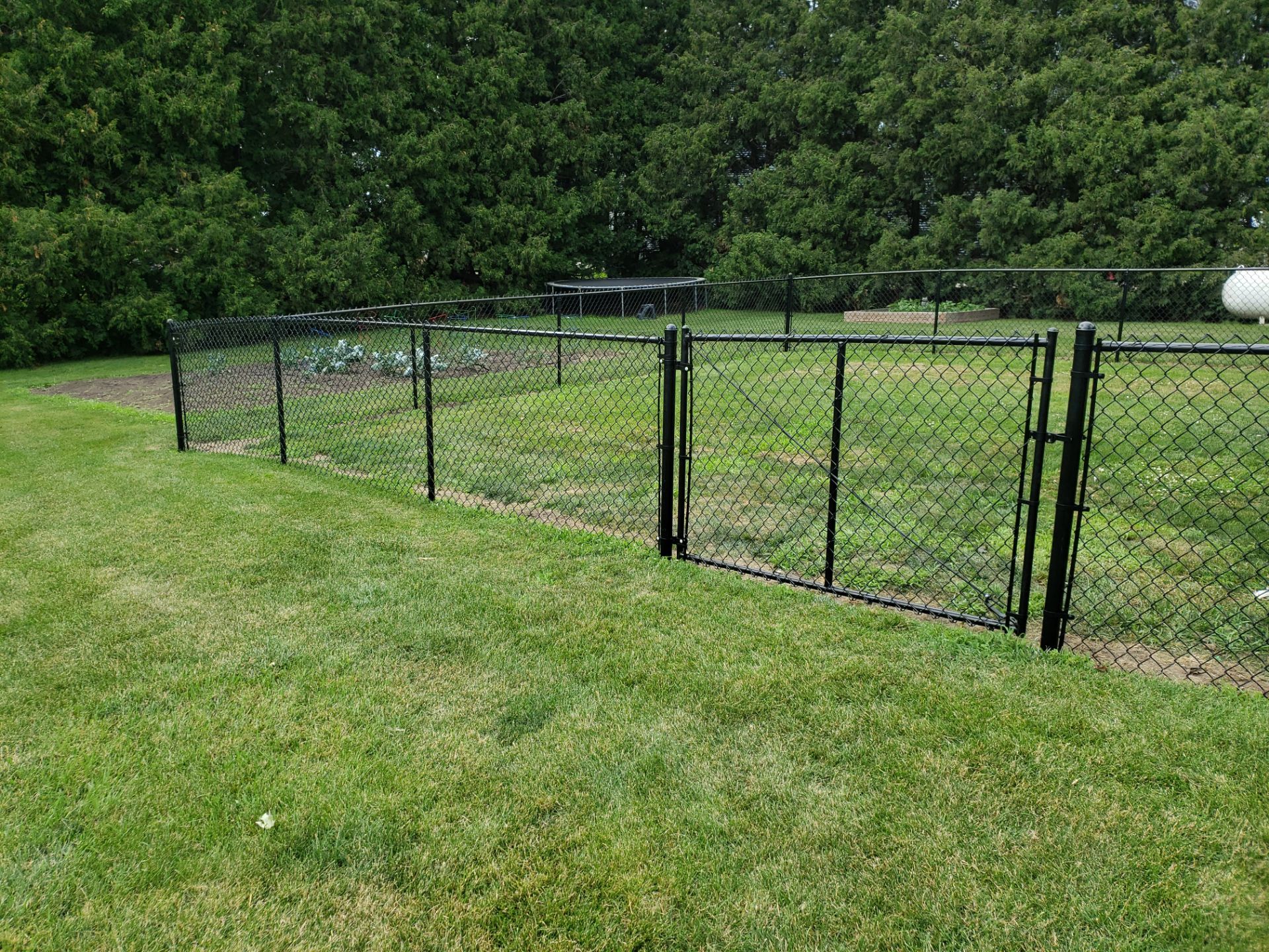 Black Vinyl-Coated Chain Link Fence Installation in Fredericksburg by Perfect Picket Fence and Stain