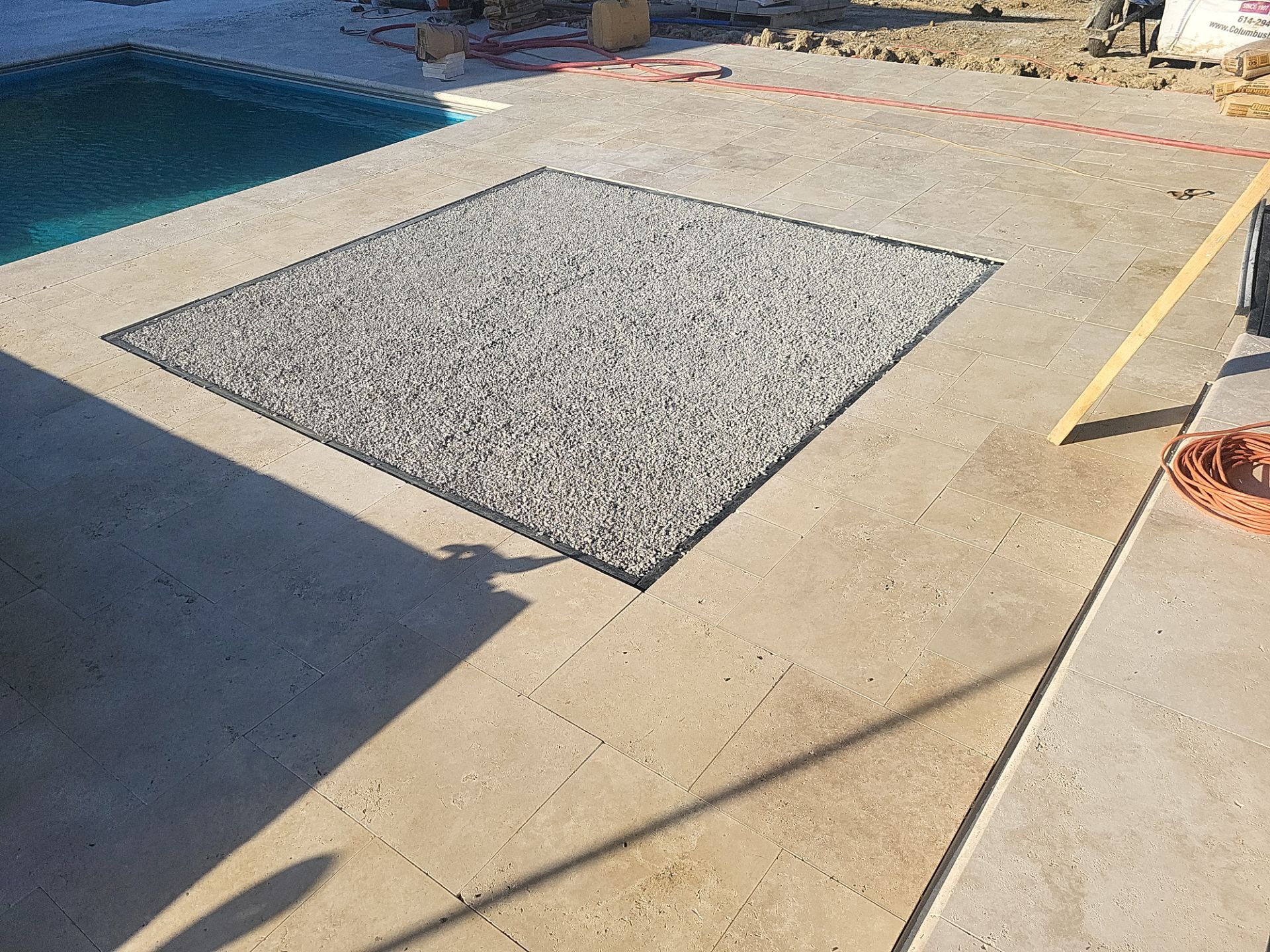 Custom Travertine Pool Deck with Artificial Turf Insets in Delaware by Southwest Greens Midwest