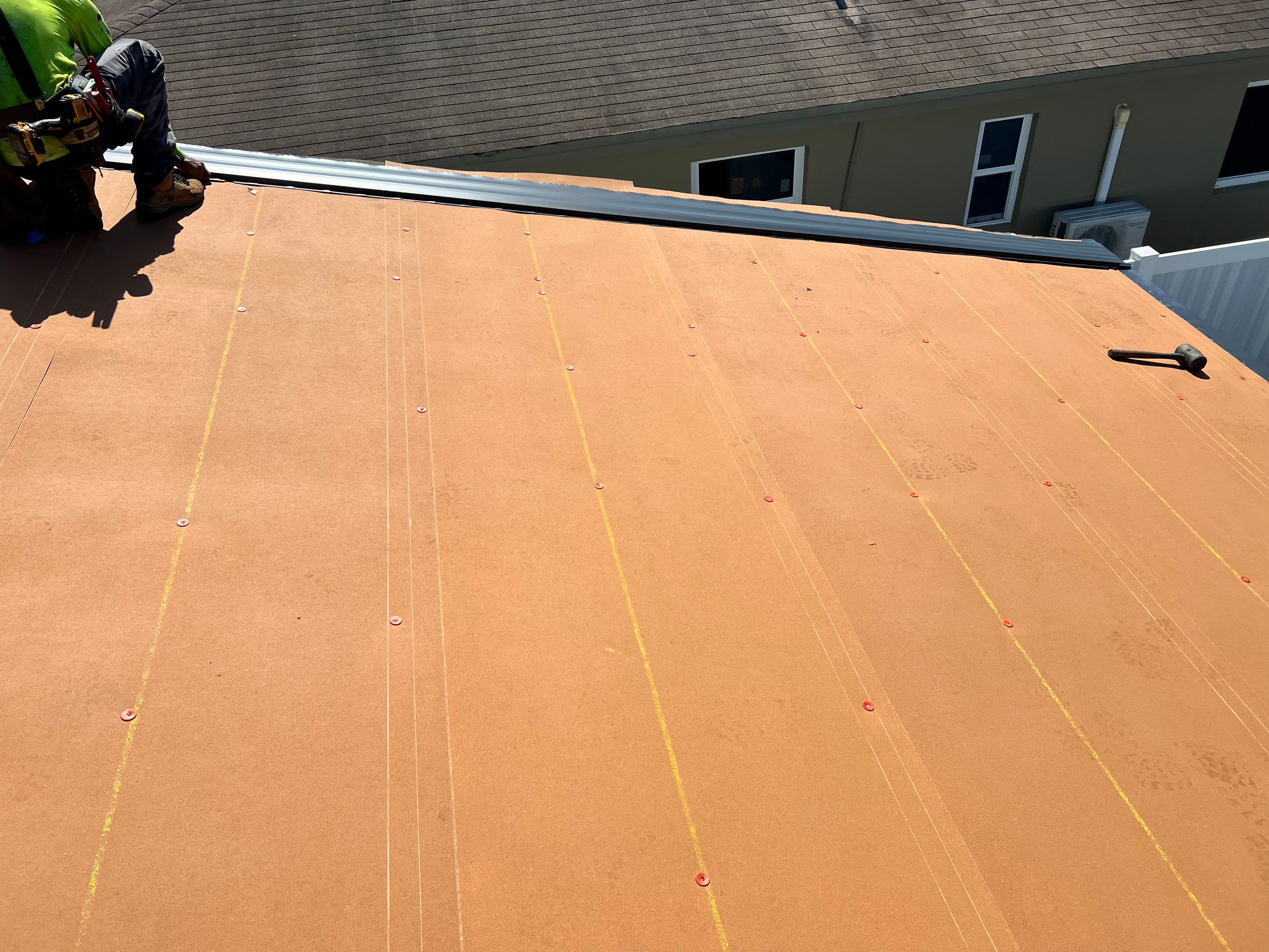 Standing Seam Metal & Flat Re-Roof using 1.5" Nail Strip 24ga Black Matte Kynar Coated Standing Seam Metal Panels by Morton Roofing, Inc.