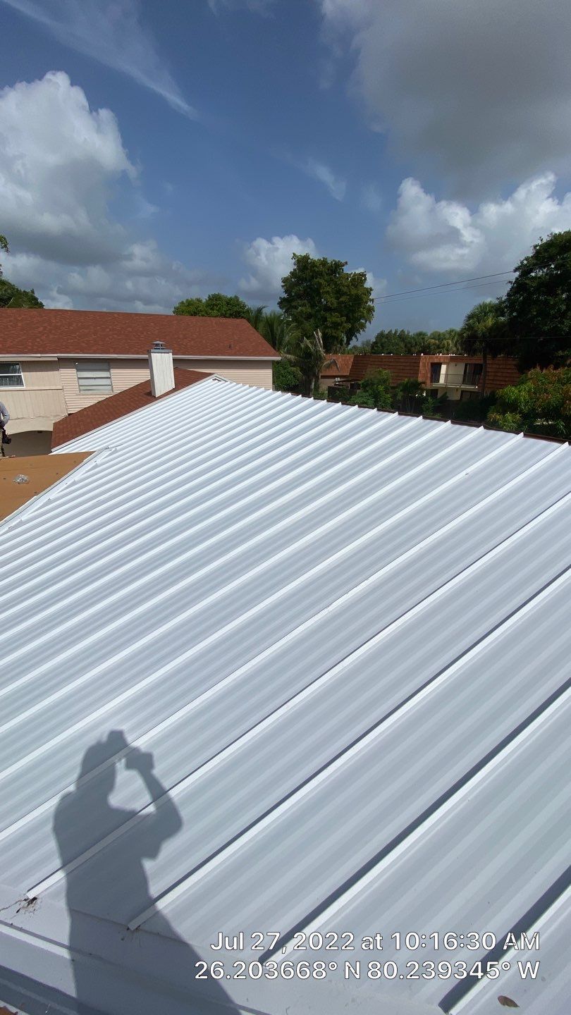 Residential Roofing Installation using 1.5" Nail Strip 24ga Solar White Kynar Coated Standing Seam Metal Panels by Morton Roofing, Inc.