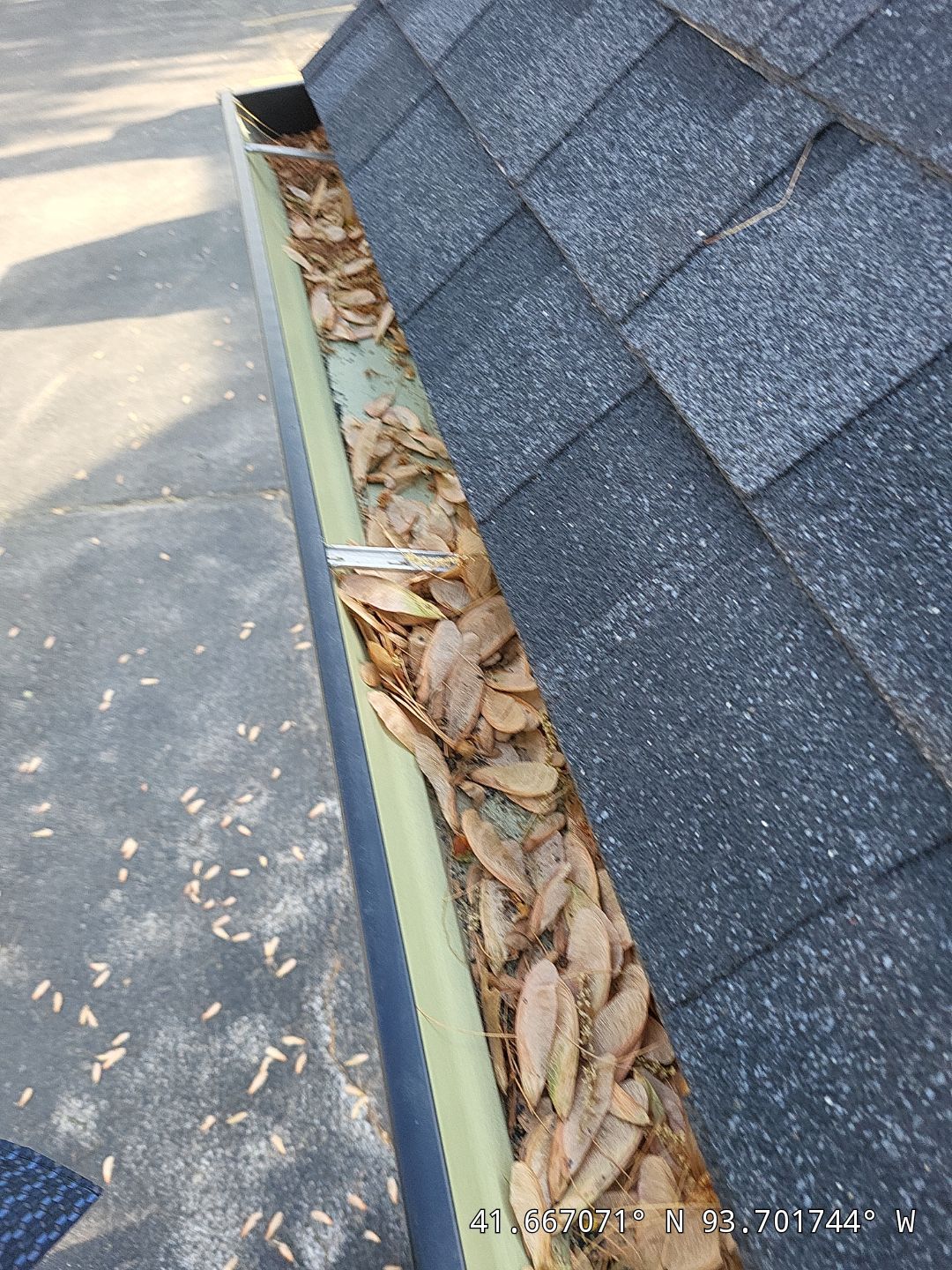 Commercial gutter cleaning Iowa before photo with filled gutters