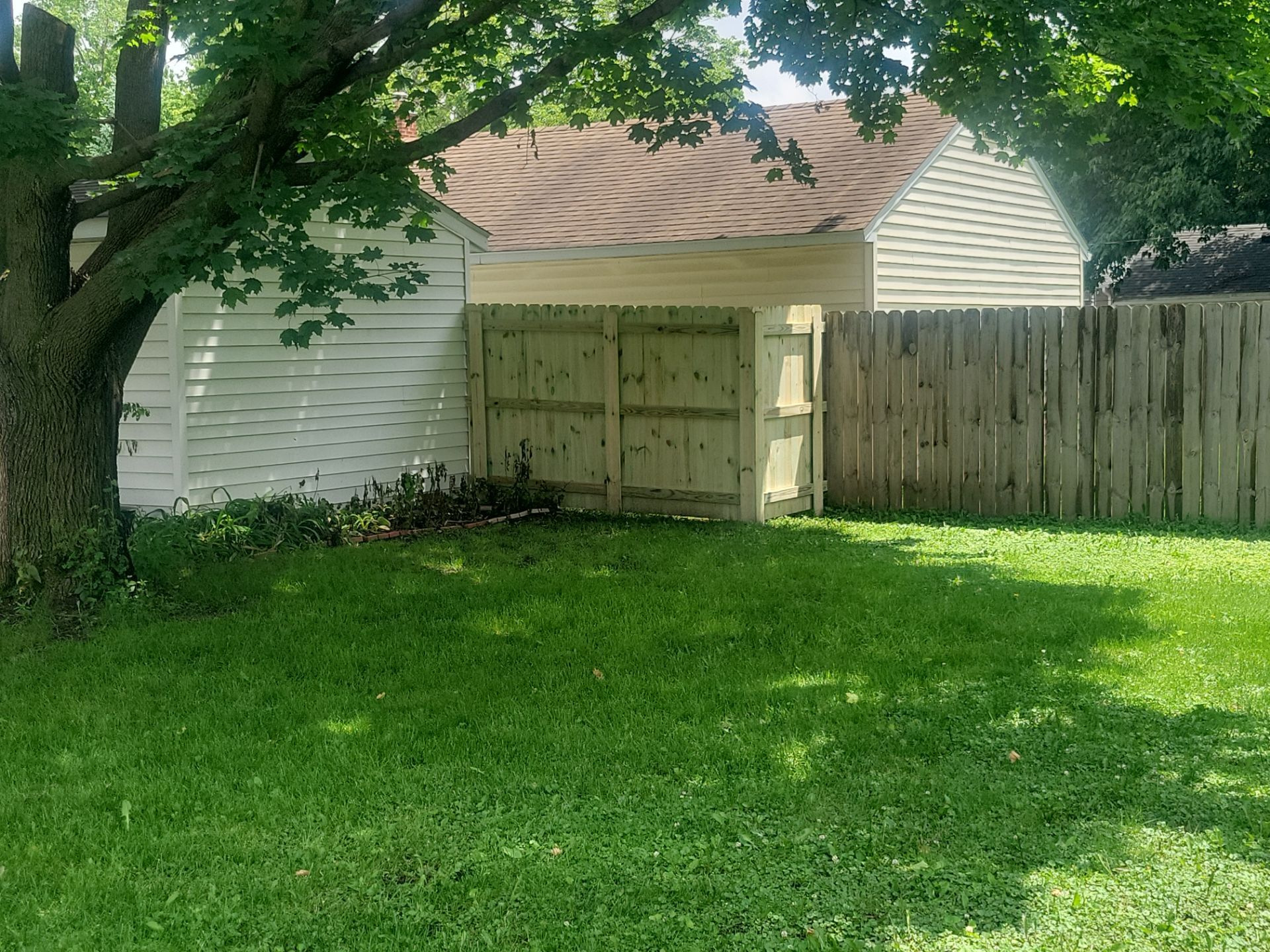 Pressure-Treated Wood Privacy Fence Installation in Charles City by Perfect Picket Fence and Stain