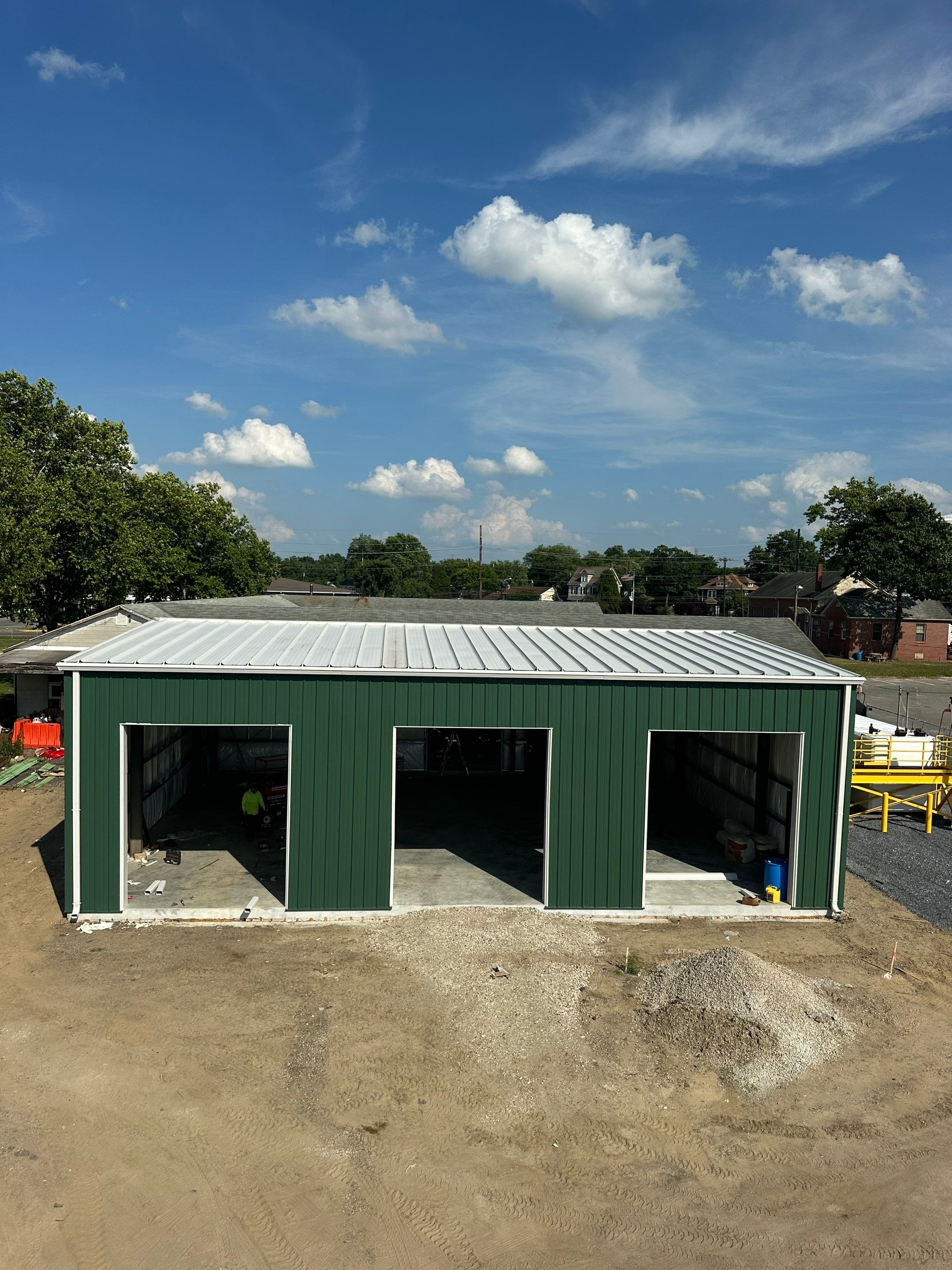 Dark Green Metal Siding by Reimagine Roofing