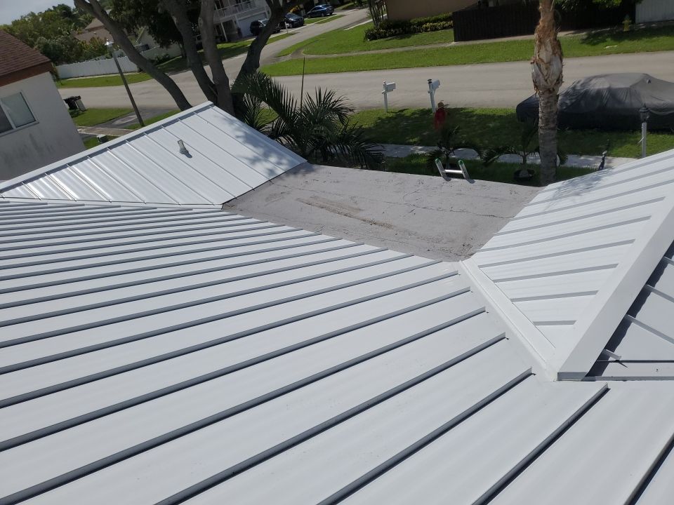 Residential Roofing Installation using 1.5" Nail Strip 24ga Solar White Kynar Coated Standing Seam Metal Panels by Morton Roofing, Inc.