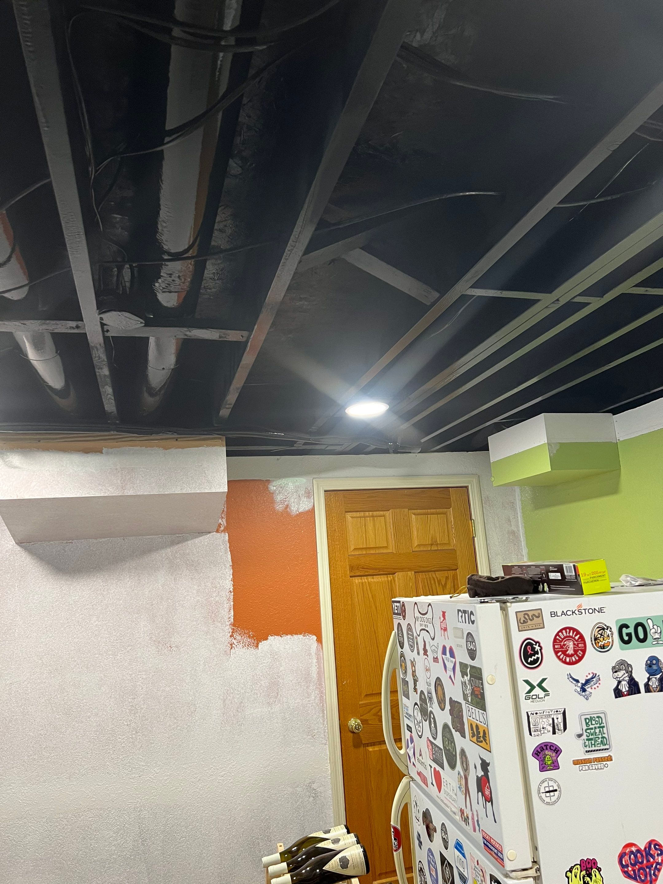 Basement Remodel with Exposed Painted Ceilings and Laminate Flooring in Mequon by OCS Contracting Services