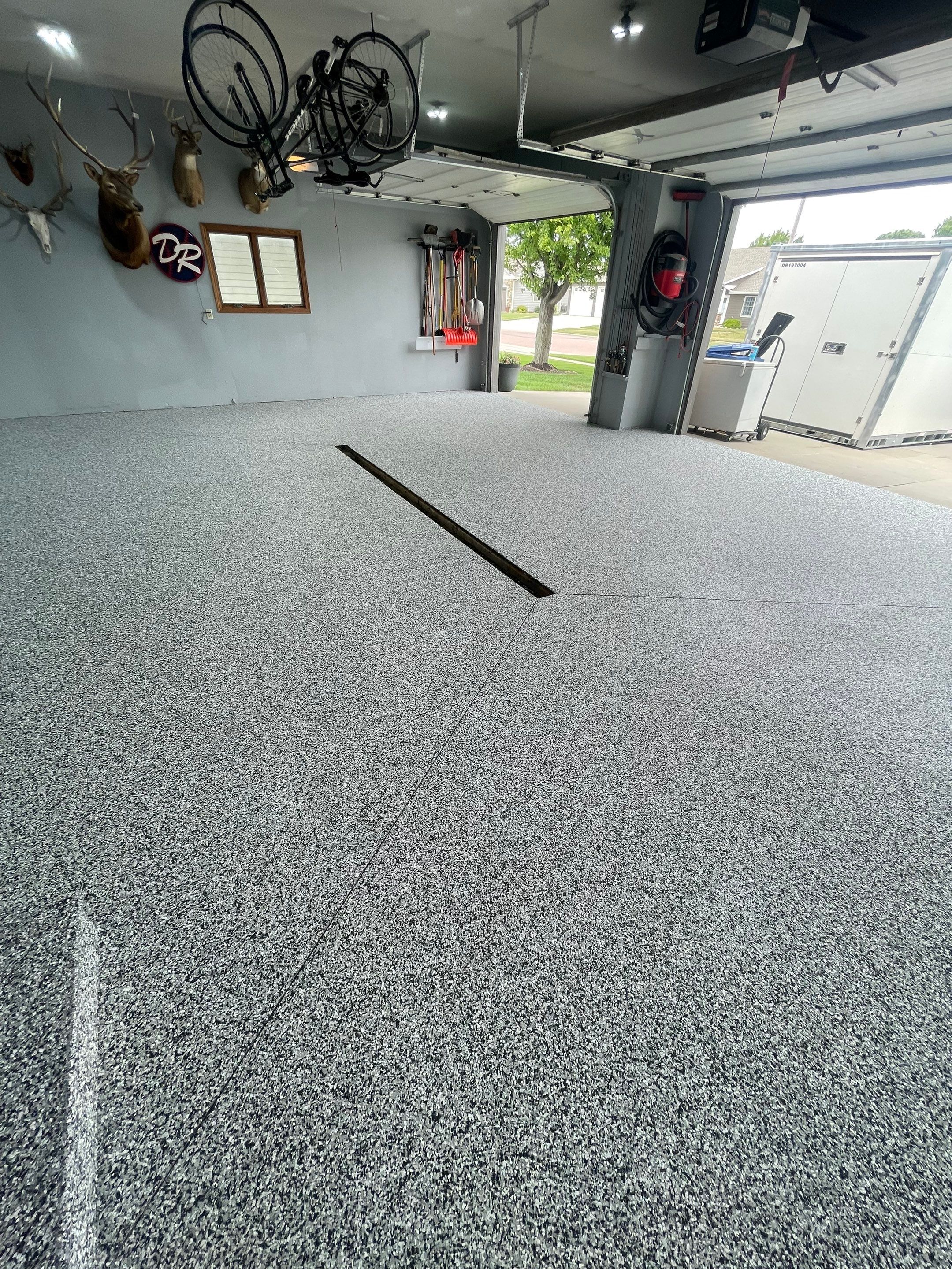 Full Garage Floor Epoxy Coating Installation in Dell Rapids by Select Painting, Coatings & Garage Cabinets