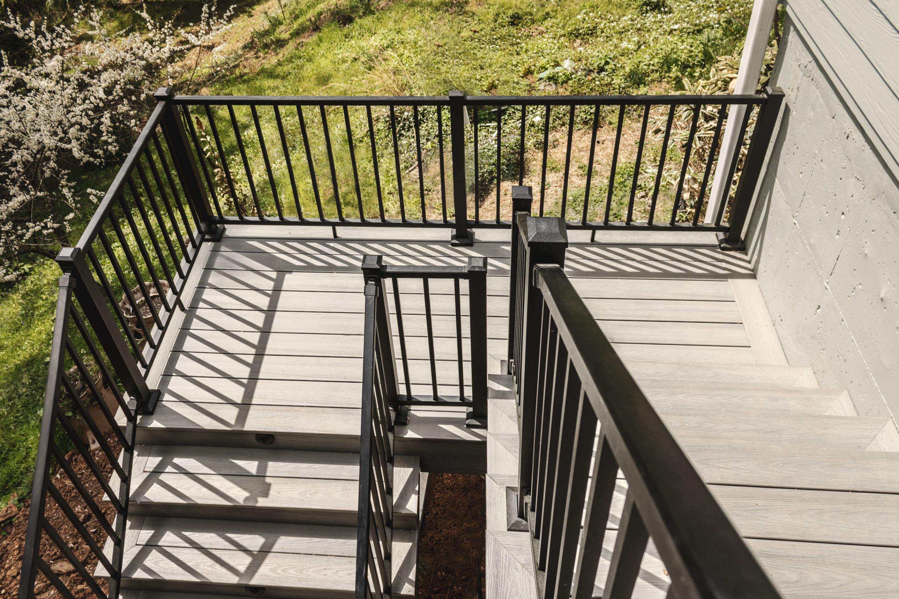 Covered Porch and Deck Build using Deckorators Venture Series Decking and Trex Select Aluminum Railing by Nelson Exteriors