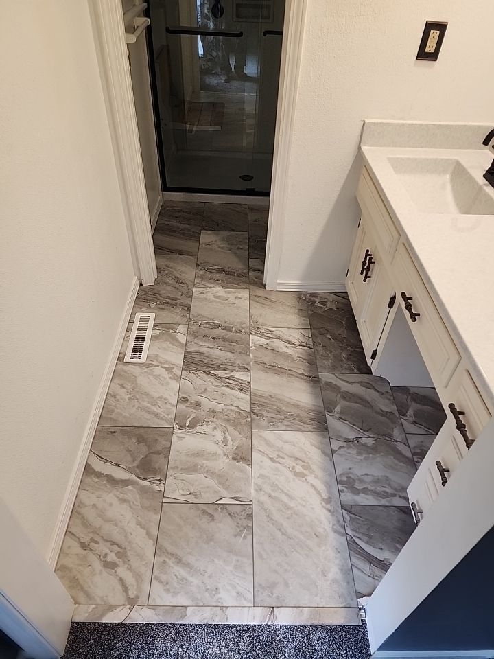 New shower, flooring, and countertop by The Shower Company
