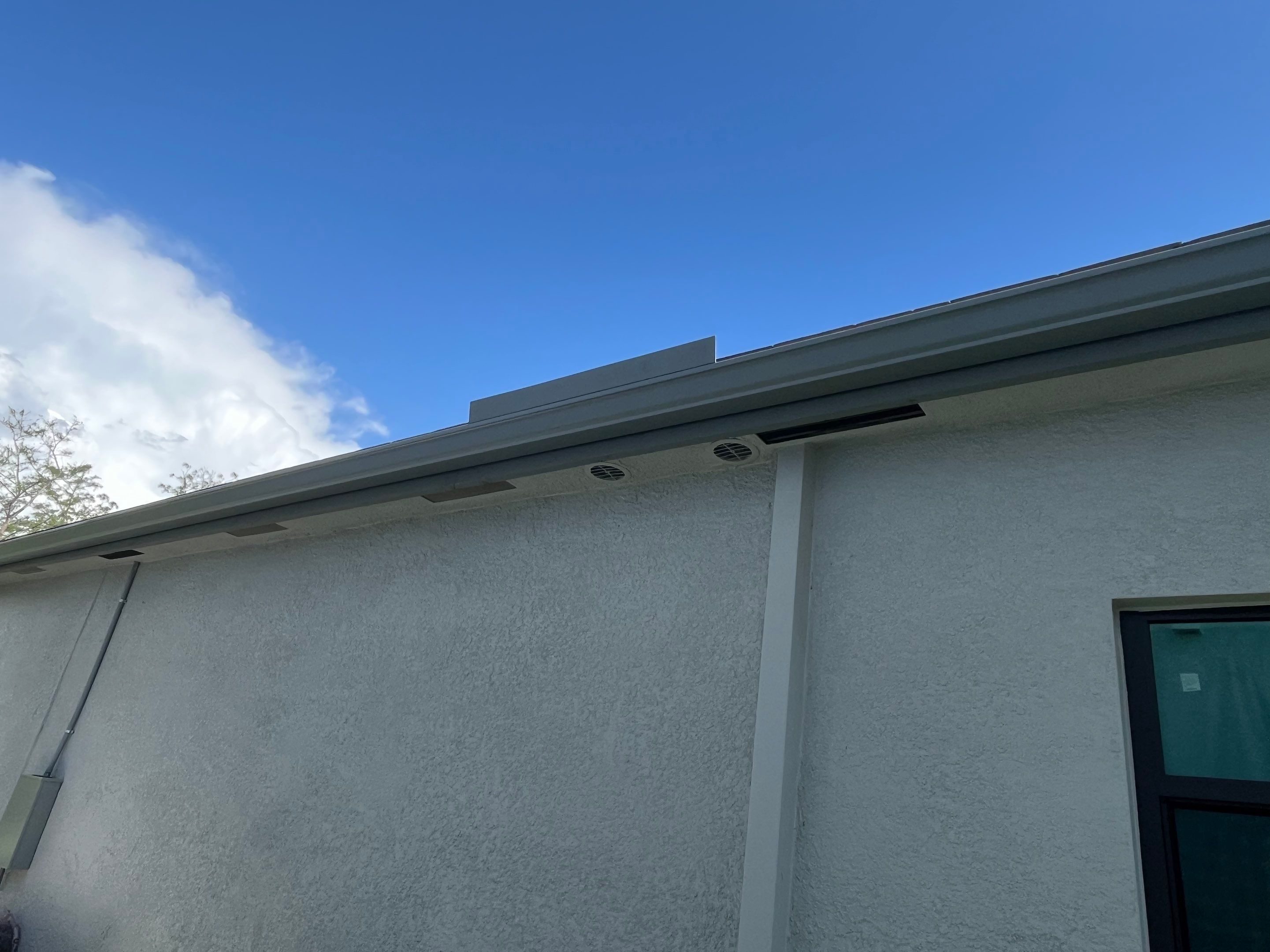 Grey Seamless Gutter Installation in Estero FL by Gutter Professors