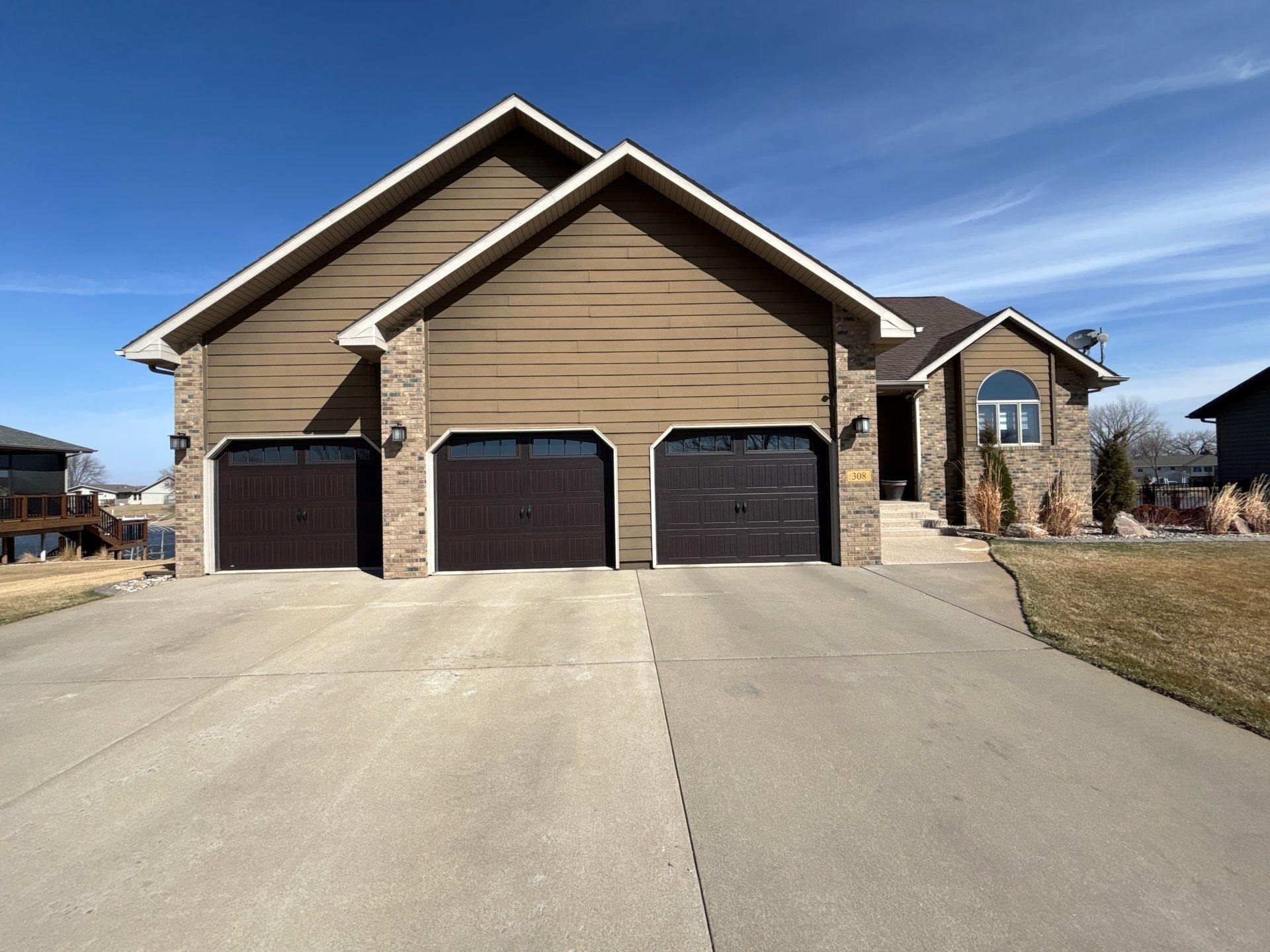 Full Exterior Renovation with Stone Veneer and Composite Decking by Select Painting, Coatings & Garage Cabinets