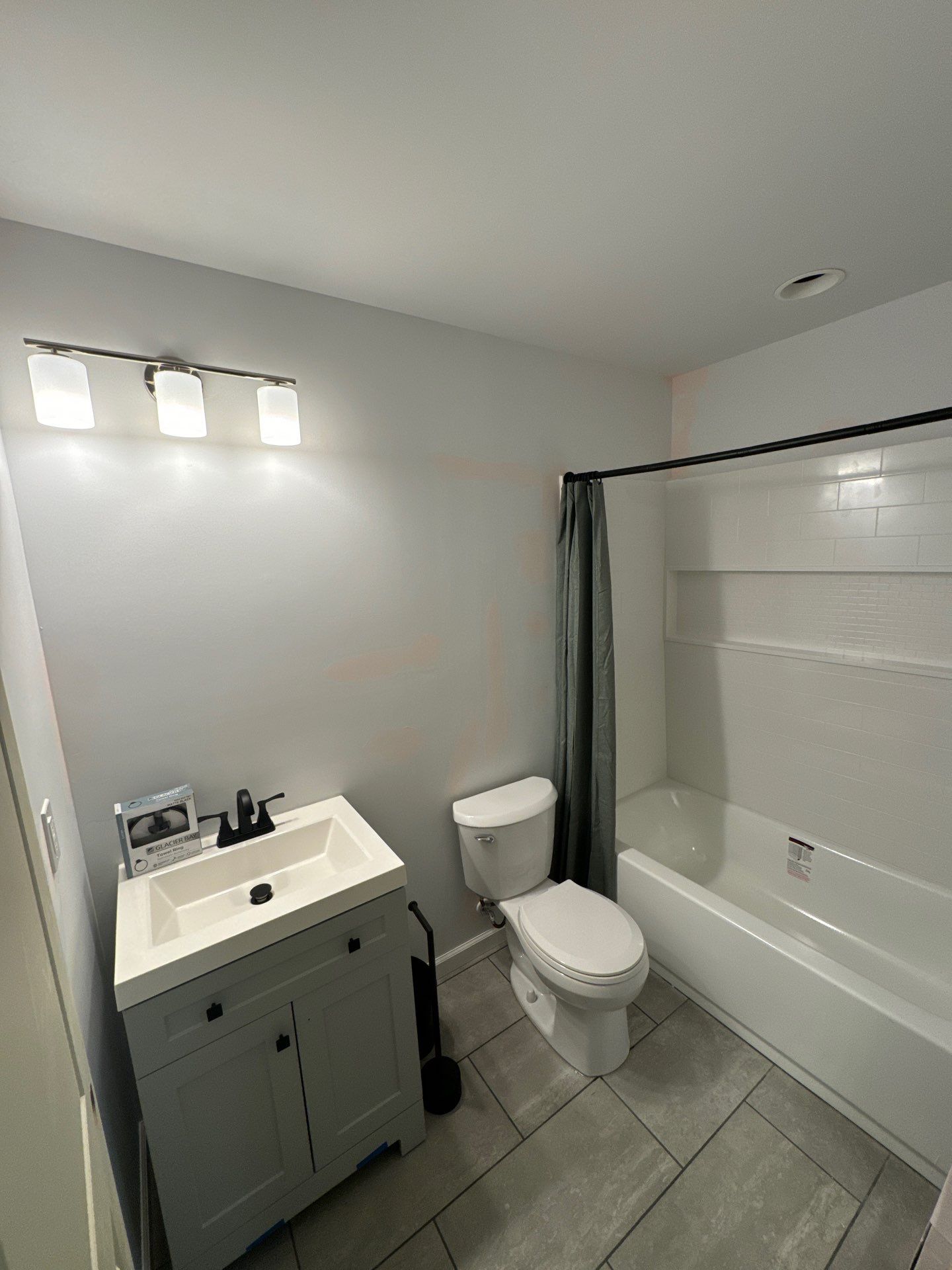 Finished Basement in Acworth Featuring a Full Bathroom and Bar by Swift Home Renovations