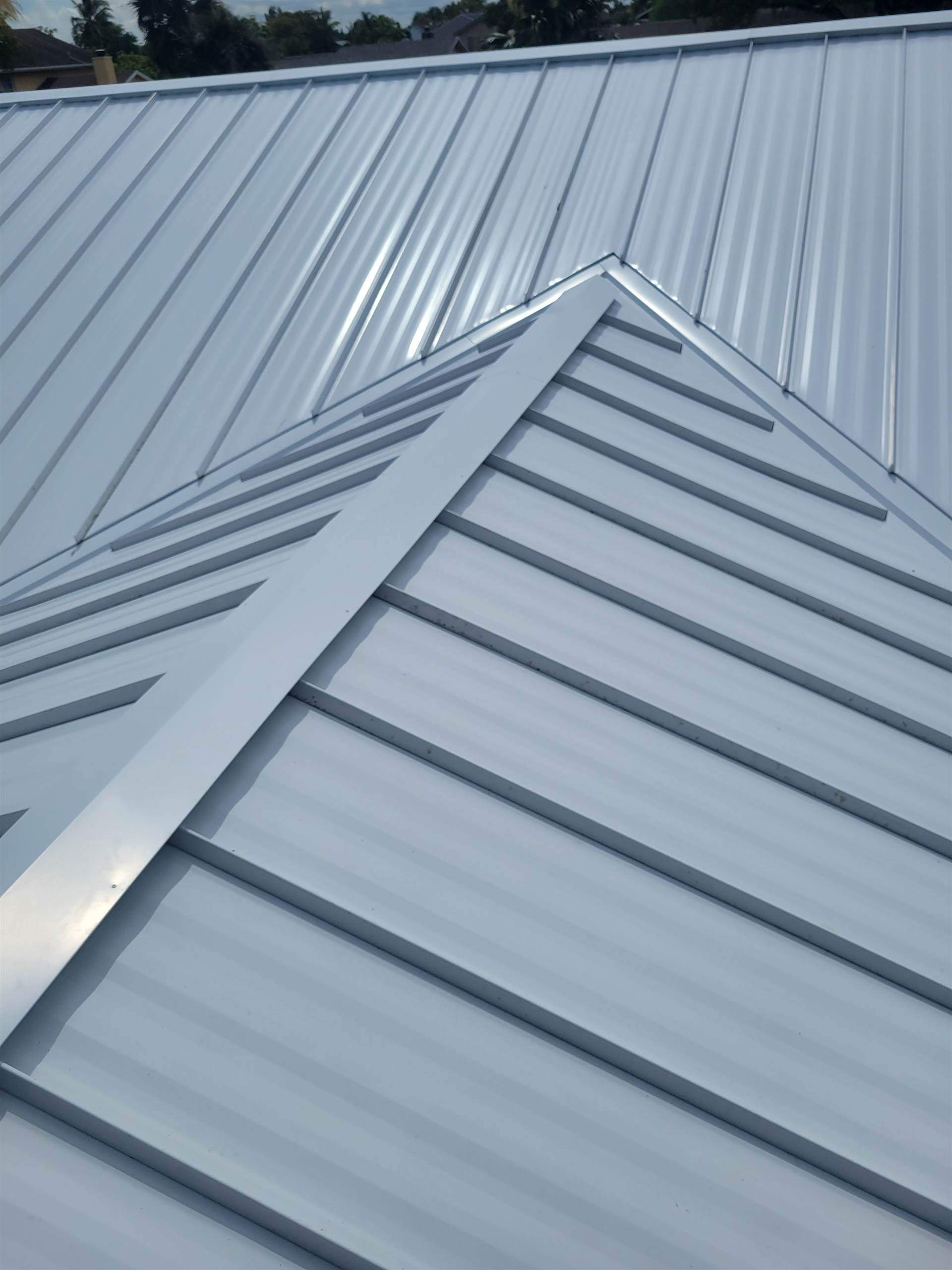 Standing Seam Metal & Flat Re-Roof using 1.5" Nail Strip 24ga Solar White Kynar Coated Standing Seam Metal Panels by Morton Roofing, Inc.