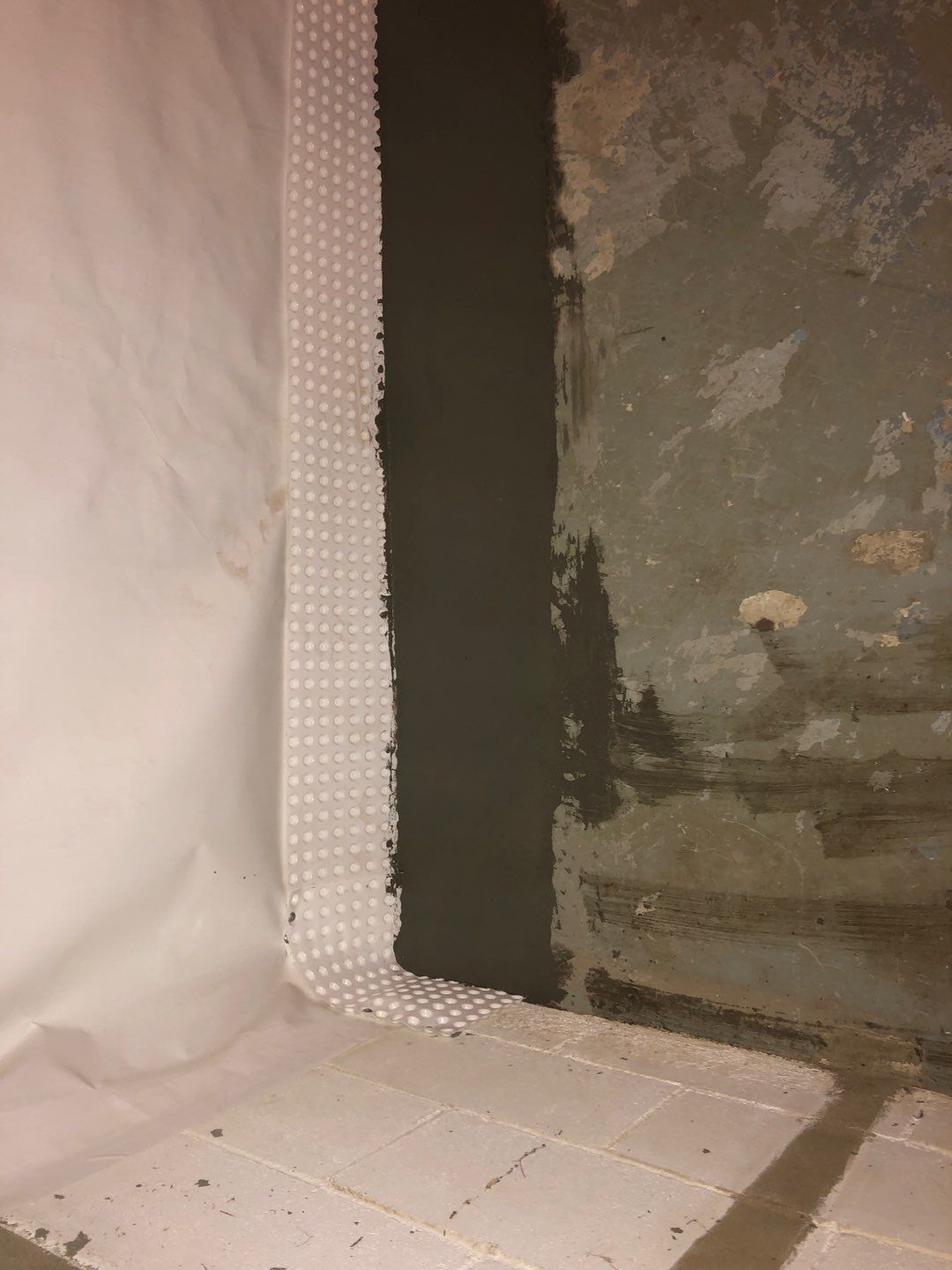 Basement Waterproofing using Drain tile system and a foundation wrap by ACE Waterproofing & Basement Solutions