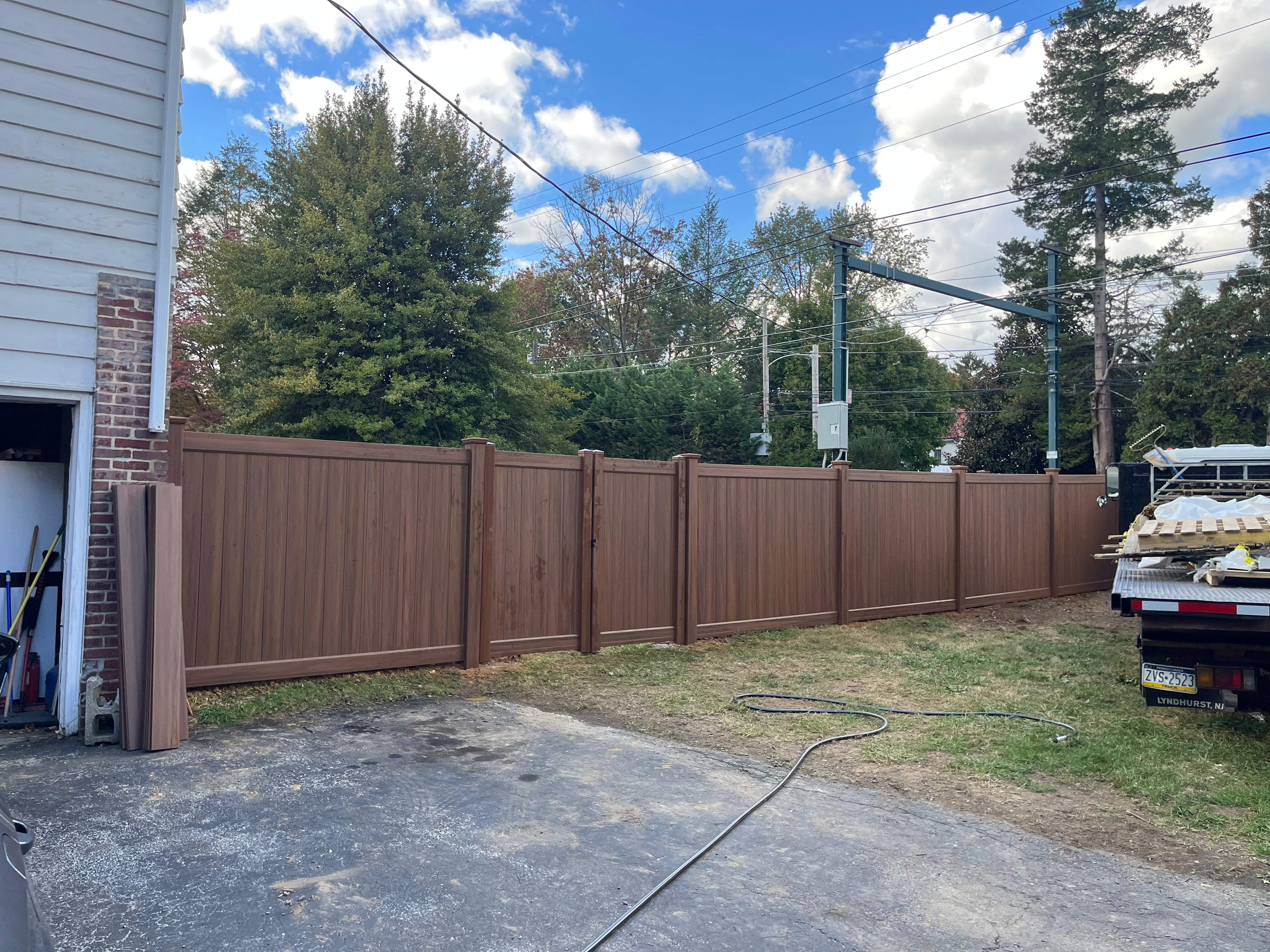 6' High Mocha Walnut Vinyl Installation by Jensen Fencing