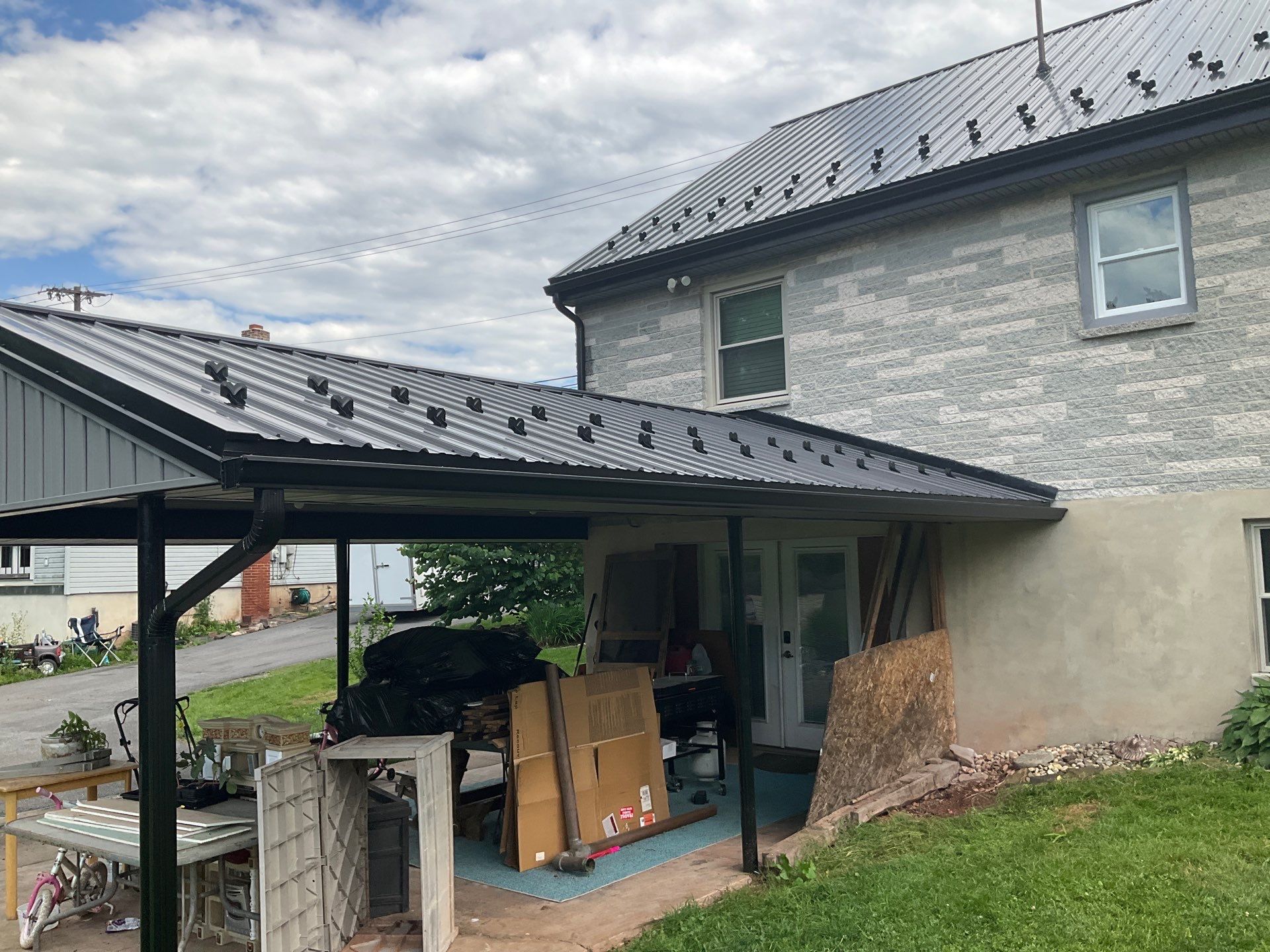Metal Roofing, Board & Batten Siding, and Entry Door Transformation by Esh Builders