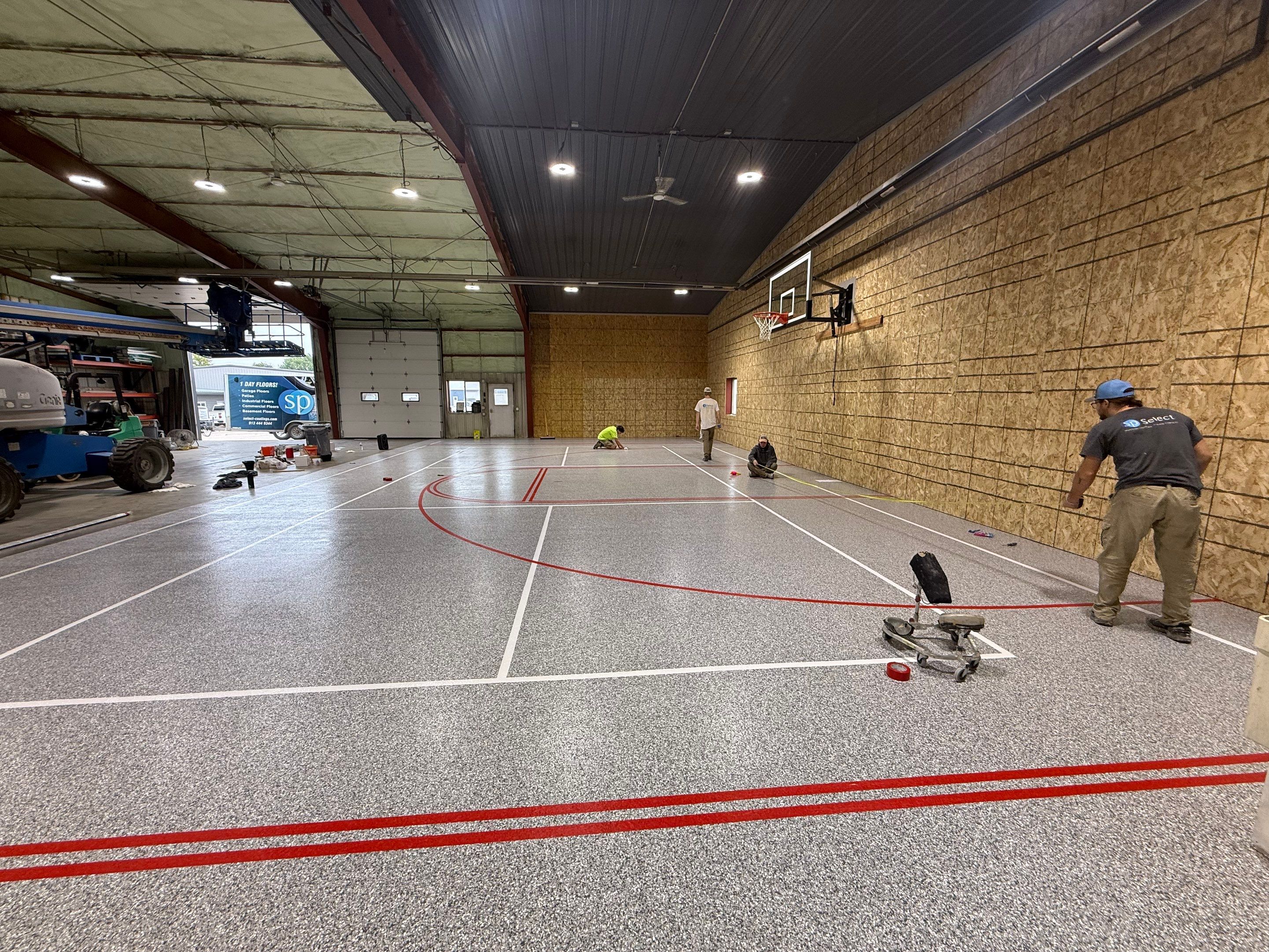 Custom Polyurea Shop Floor with Basketball Court Lines in Rock Valley by Select Painting, Coatings & Garage Cabinets