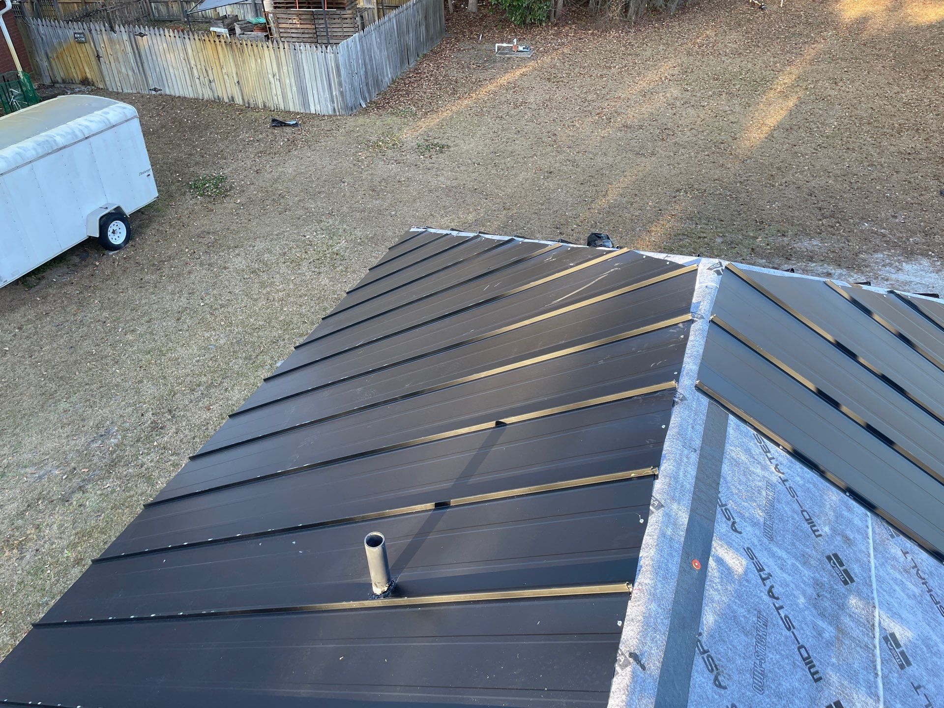 Residential Roofing Installation using Benton 26Ga 1inc Snapcock Metal Roof KYNAR Matte Black by Talya Roofing