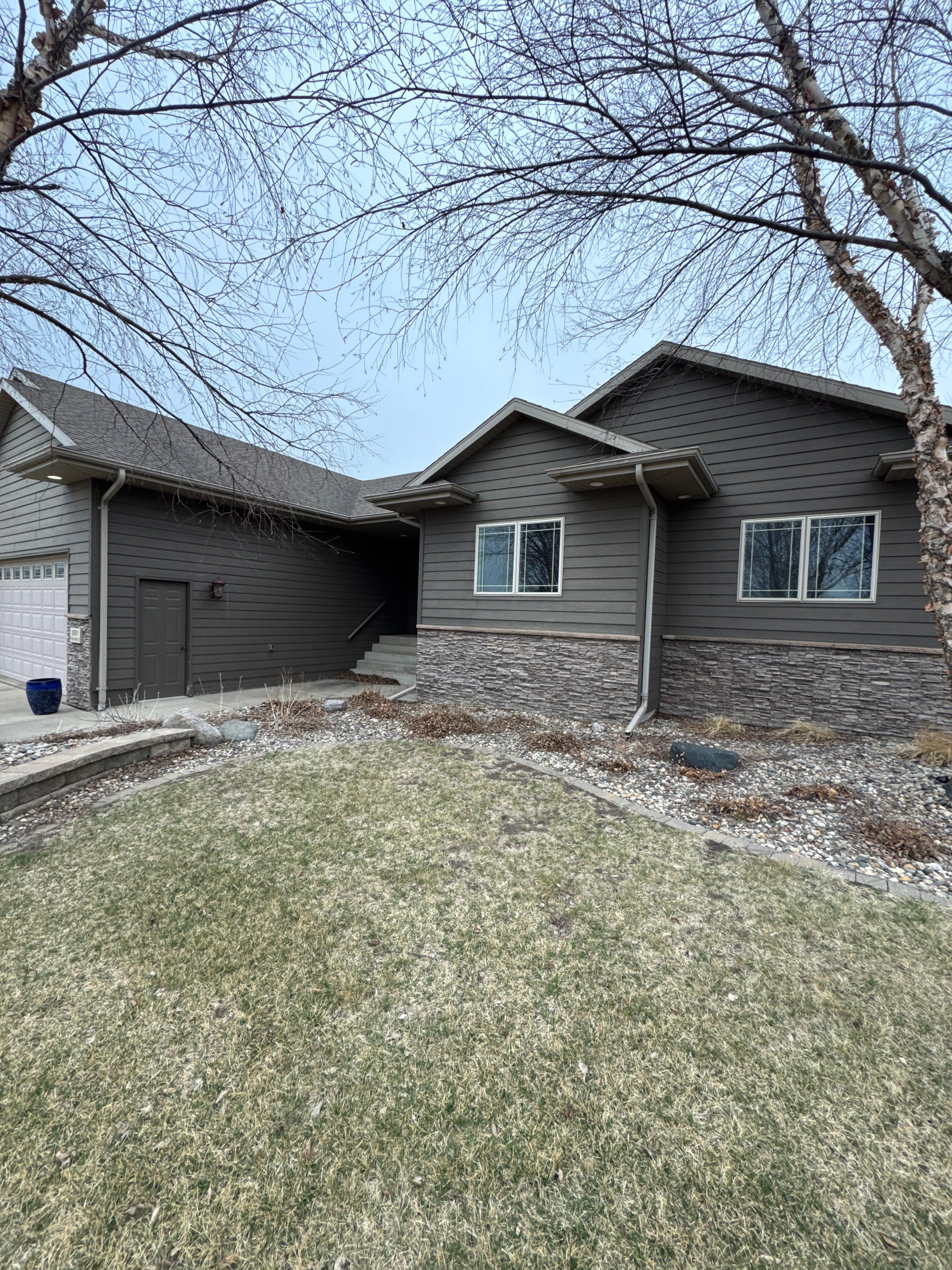Sioux Falls Residential Exterior Update and Flagstone Pool Deck by Select Painting, Coatings & Garage Cabinets