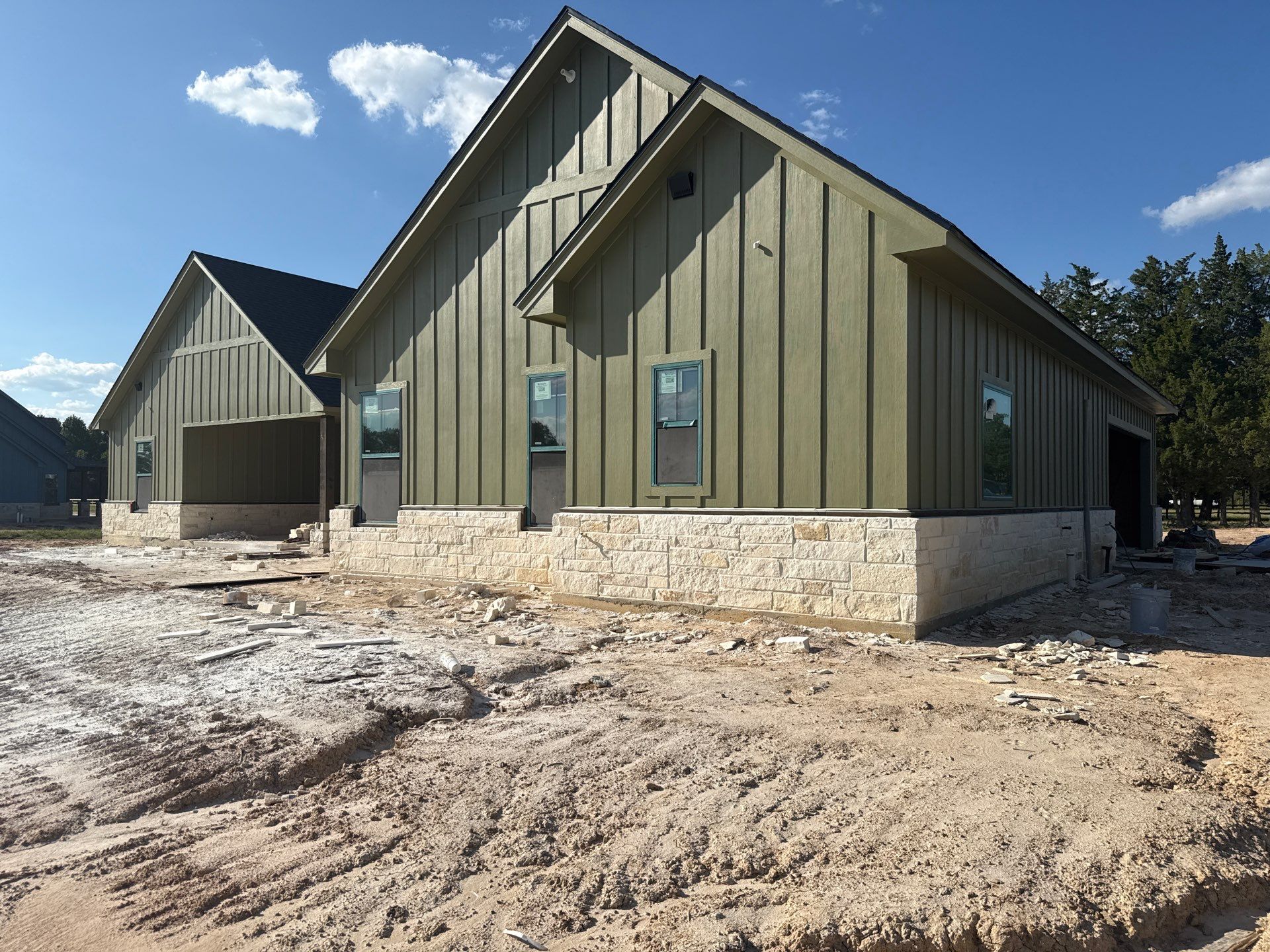Cleveland Ranch Charm: Natural Stone Wainscot with Green Accent Siding. by Apex Conventional Stucco Llc