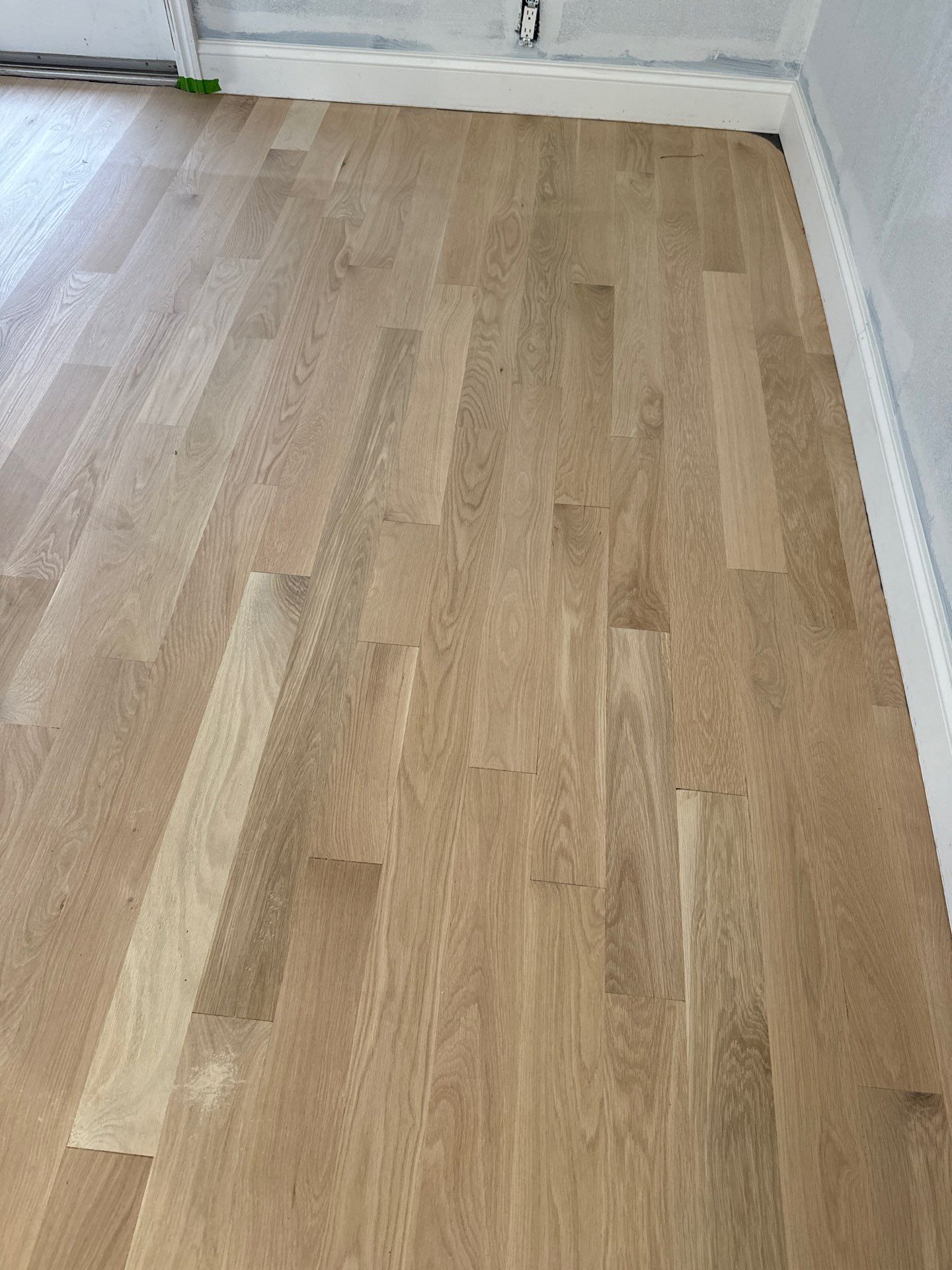 New Flooring installation using 4" White oak select grade plain sawn Ebony Stain by Ann Arbor Hardwoods