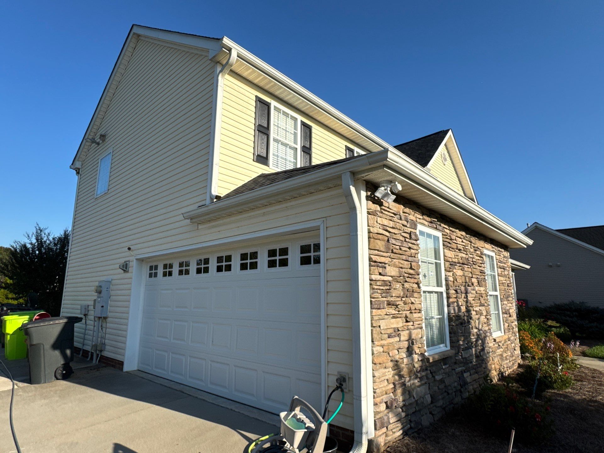 the service involves cleaning the siding and stone surfaces of the house using a pressure washing technique