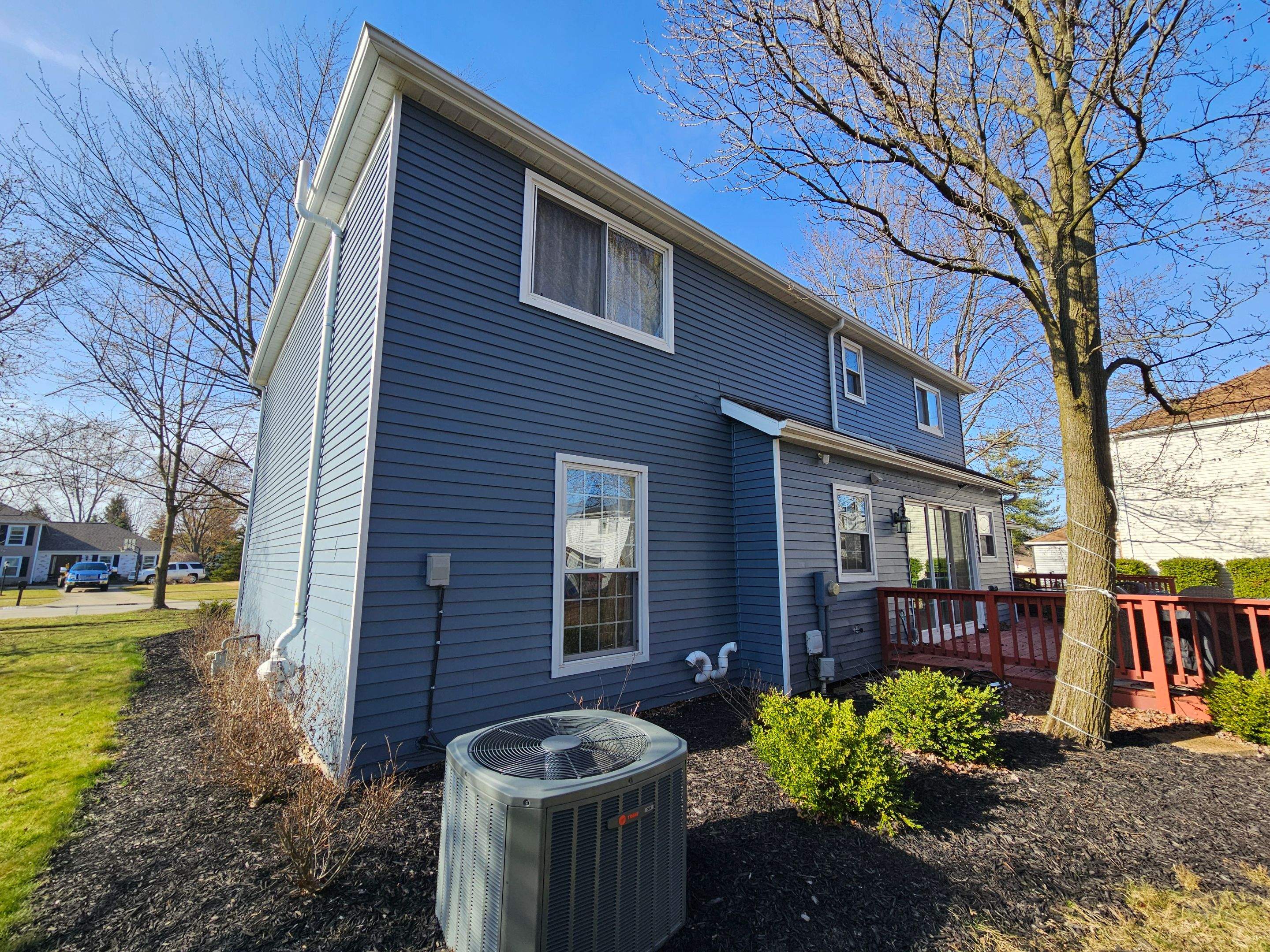 Vinyl Siding w. Stone Facade by Absolute Roofing and Construction