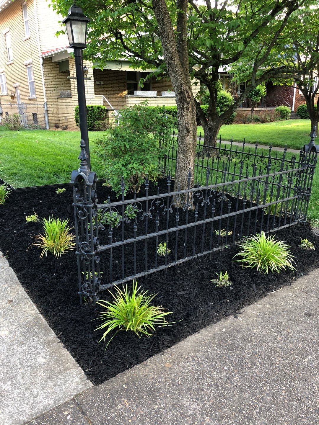 Liriope grasses, mulch and stone pavers by GrassBusters, Inc.
