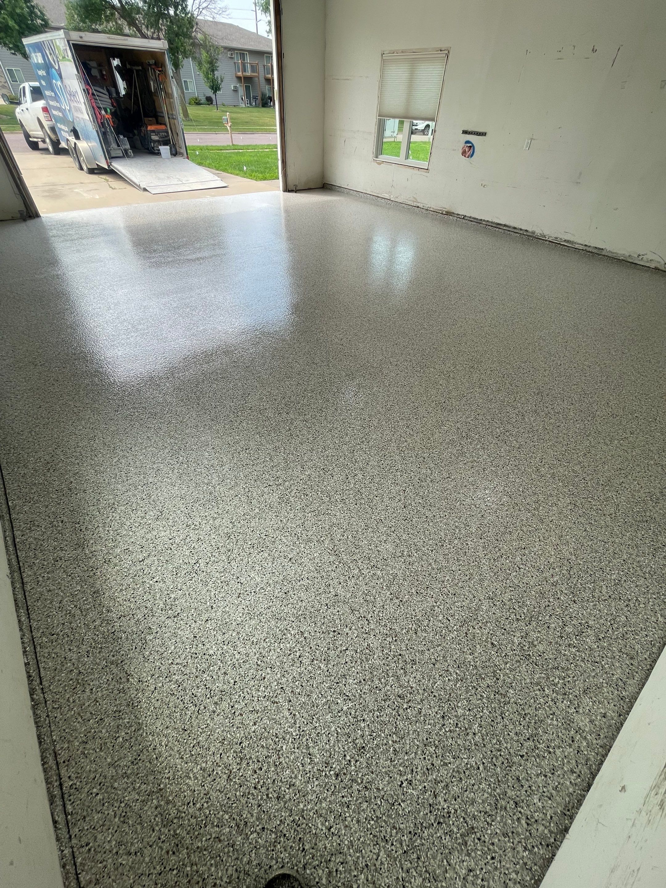 Coyote Flake Concrete Coating for Sioux Falls Garage by Select Painting, Coatings & Garage Cabinets