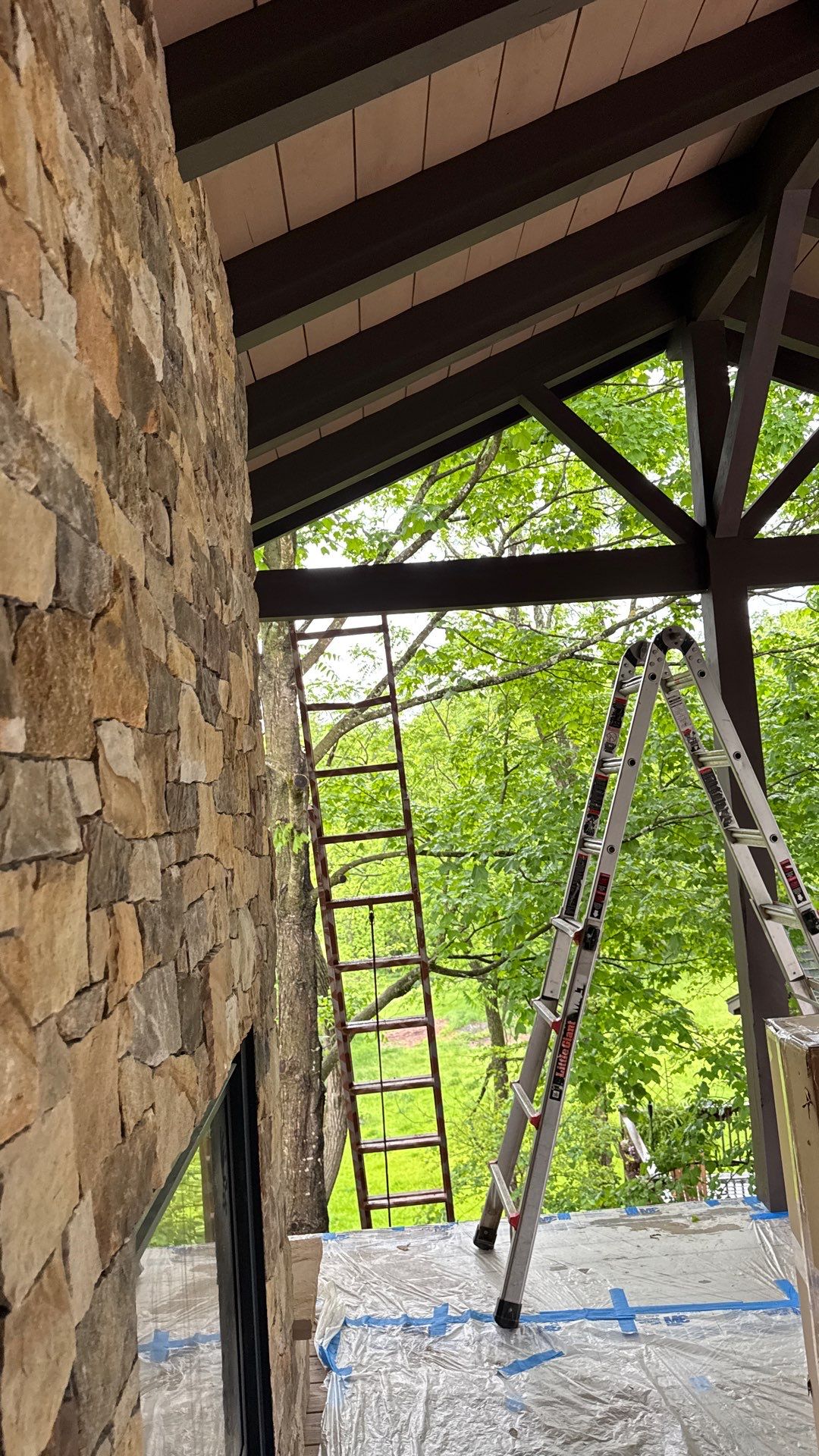 Custom Composite Deck with Stone Fireplace and Modern Cable Railing by Walnut Hollow Decks & Outdoor Living