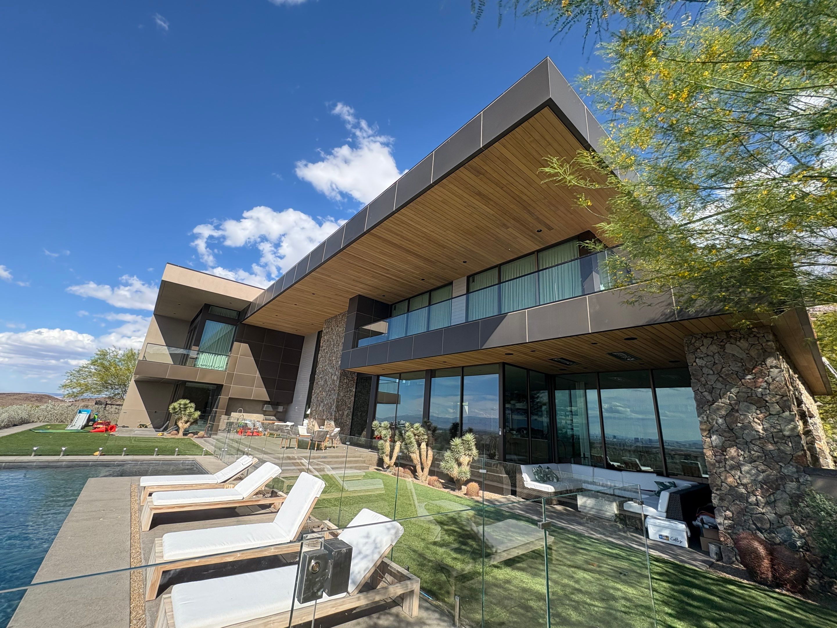 Exterior wood refinish & glass pool enclosure by Level Builders