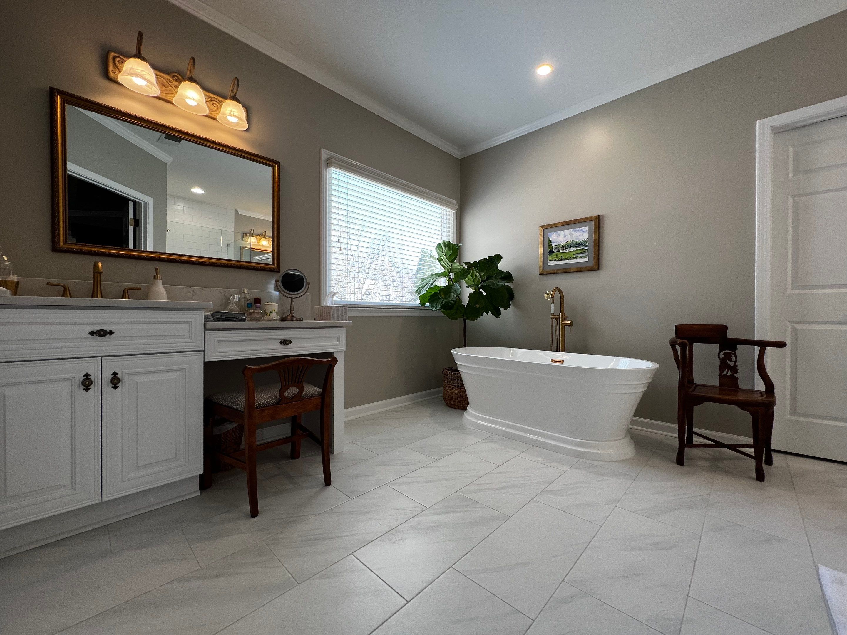 Master Bathroom Renovation with Marble Floor and Freestanding Soaking Tub by Swift Home Renovations