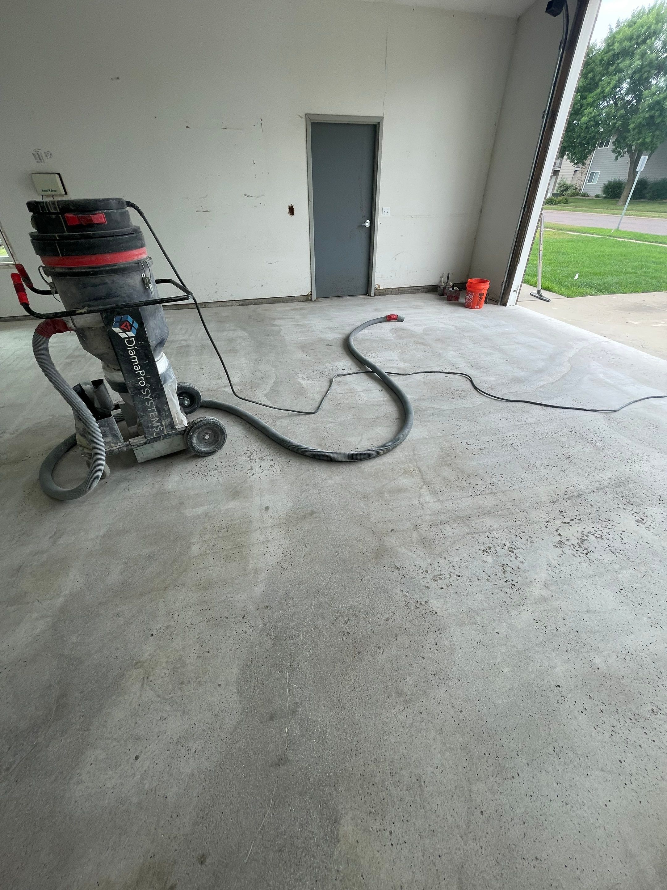 Coyote Flake Concrete Coating for Sioux Falls Garage by Select Painting, Coatings & Garage Cabinets