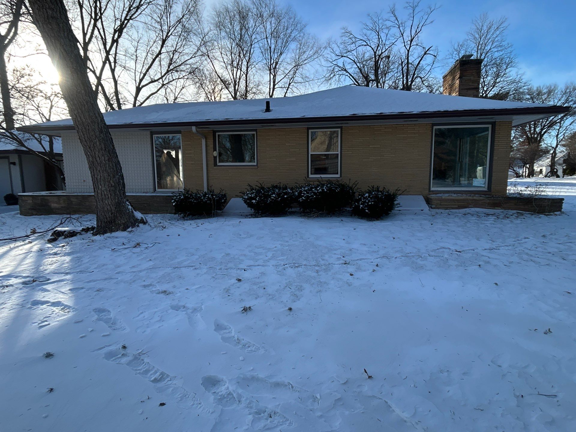 Black-Frame Pella Lifestyle Upgrade on a Partial Brick Home by United Windows and Siding LLC