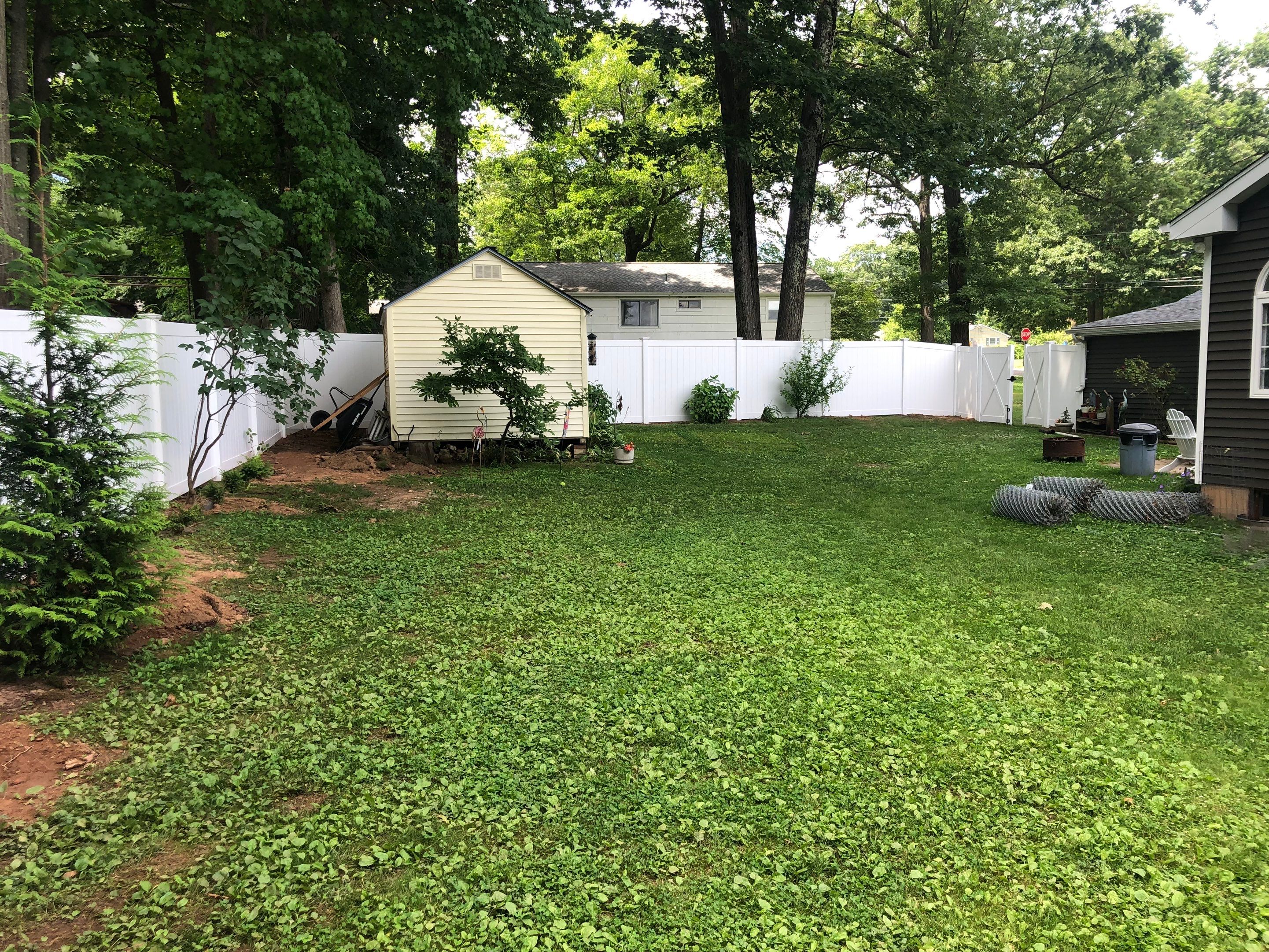 New Vinyl Privacy fence with matching drive gate in white by DiGiorgi Roofing and Siding Inc