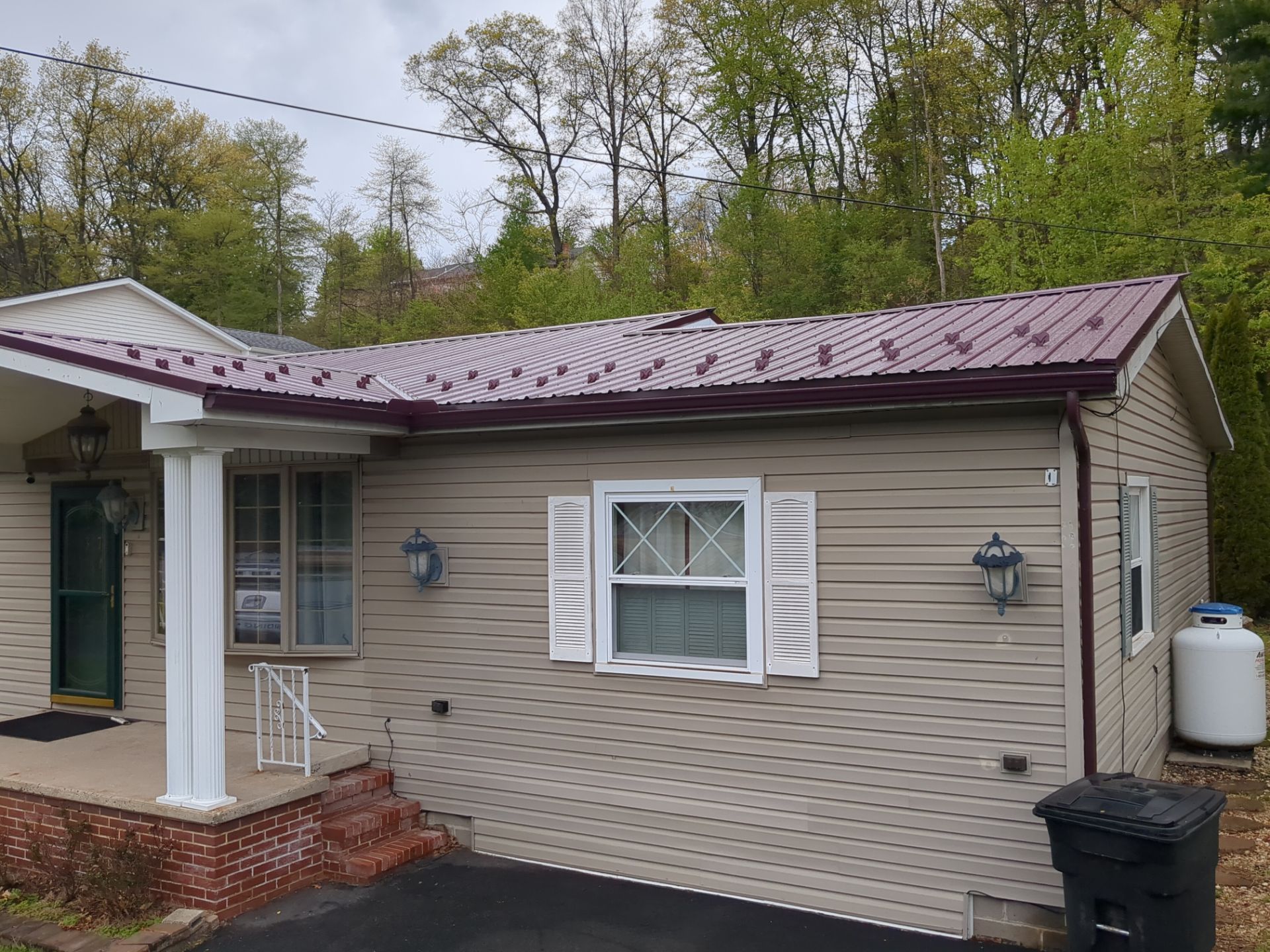Maroon ABM Metal Roof Replacement and Gutter Installation in Shenandoah by Esh Builders