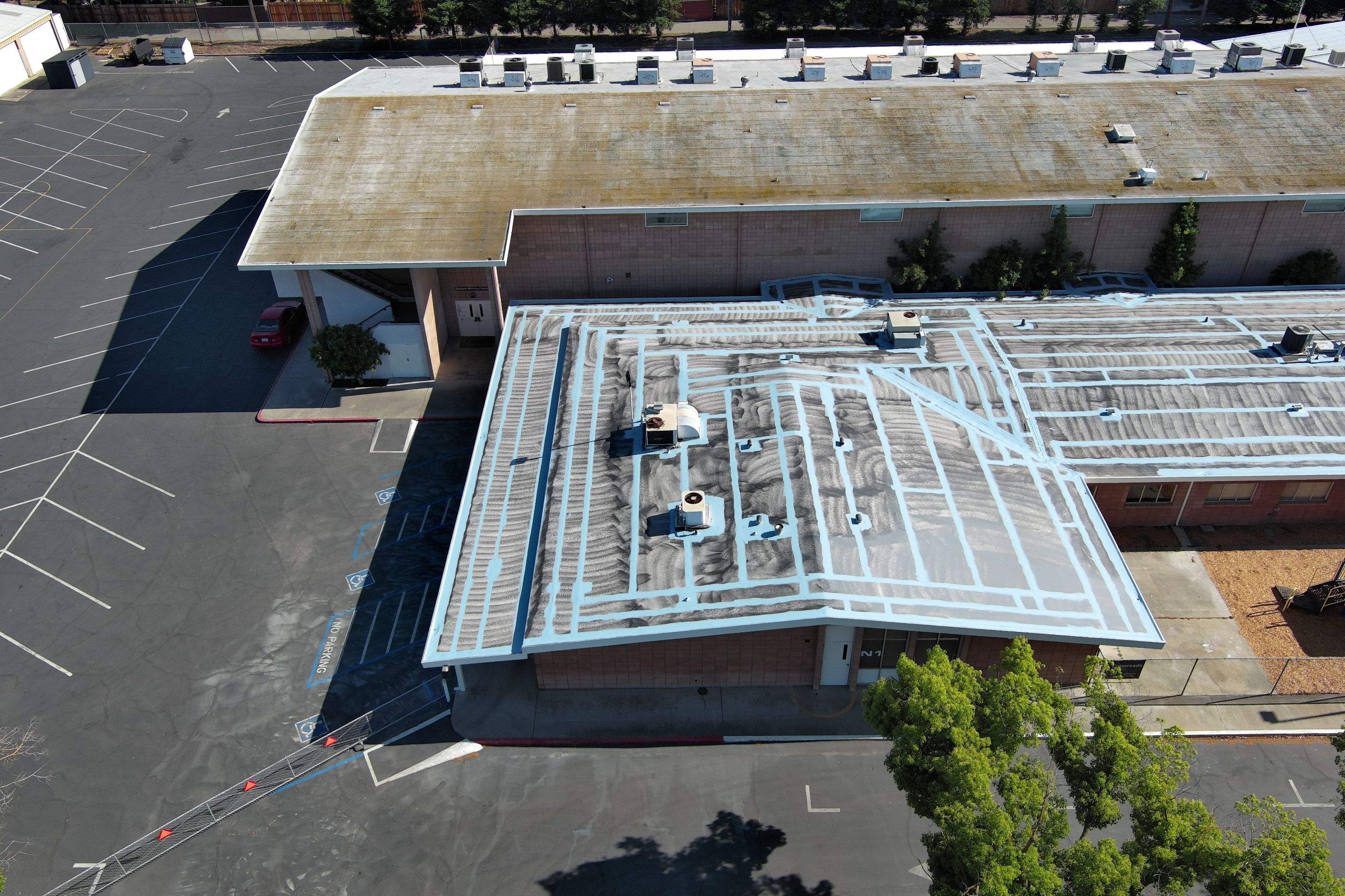 Single-ply restoration system using Benchmark/PUMA XL coatings over TPO single-ply roofing by Straight Edge Roofing Inc
