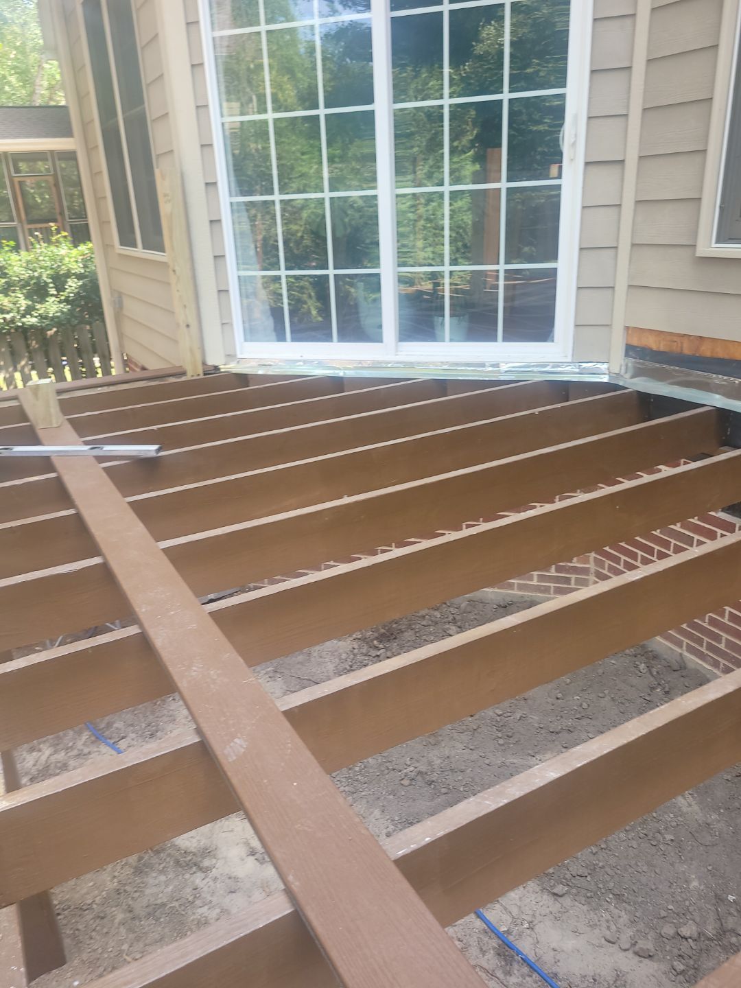 Fuquay-Varina Outdoor Upgrade – Composite Deck & Paved Landing by Elite Remodeling and Design LLC