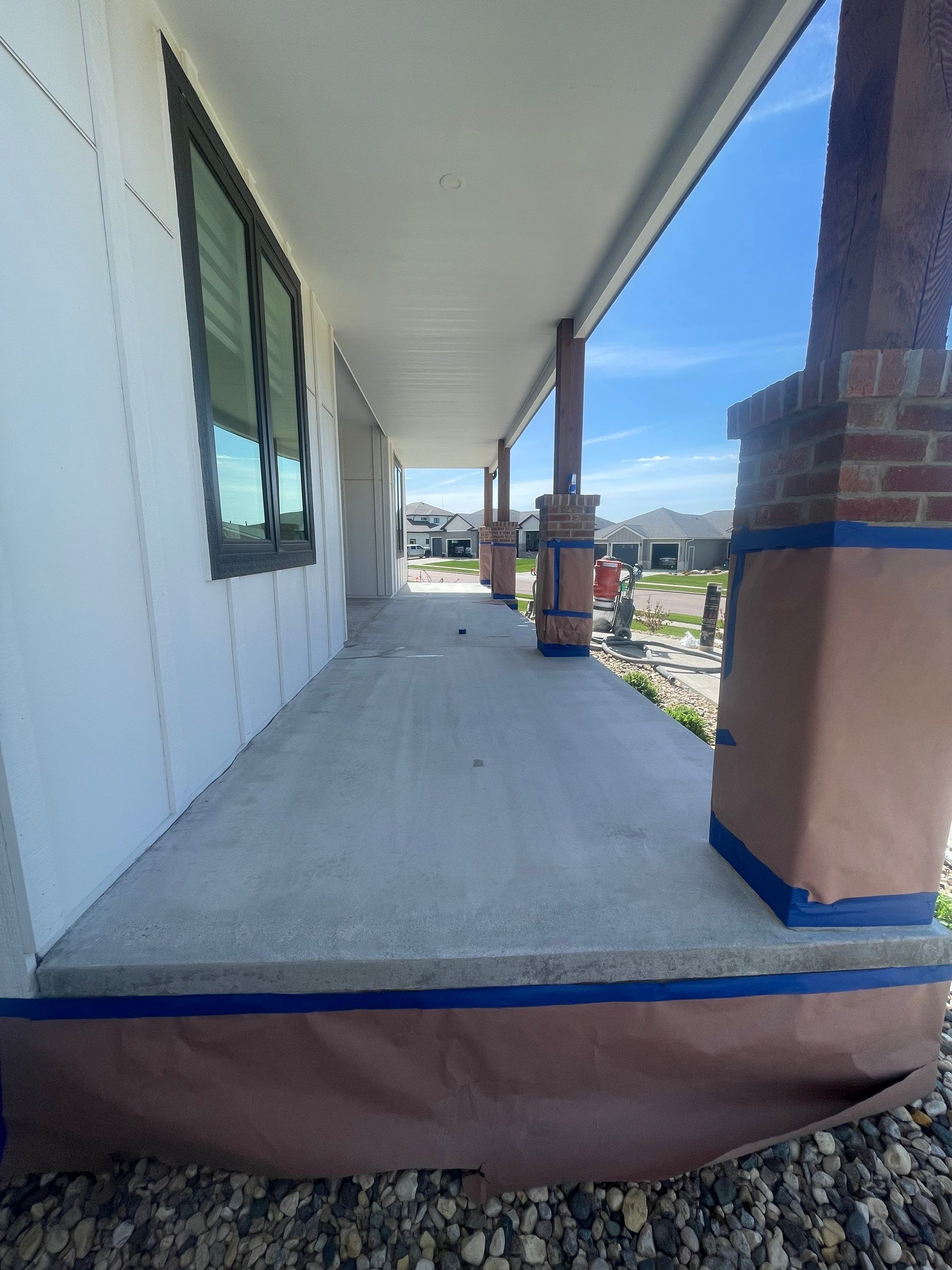 Grey Speckled Concrete Porch Coating for Sioux Falls Home by Select Painting, Coatings & Garage Cabinets