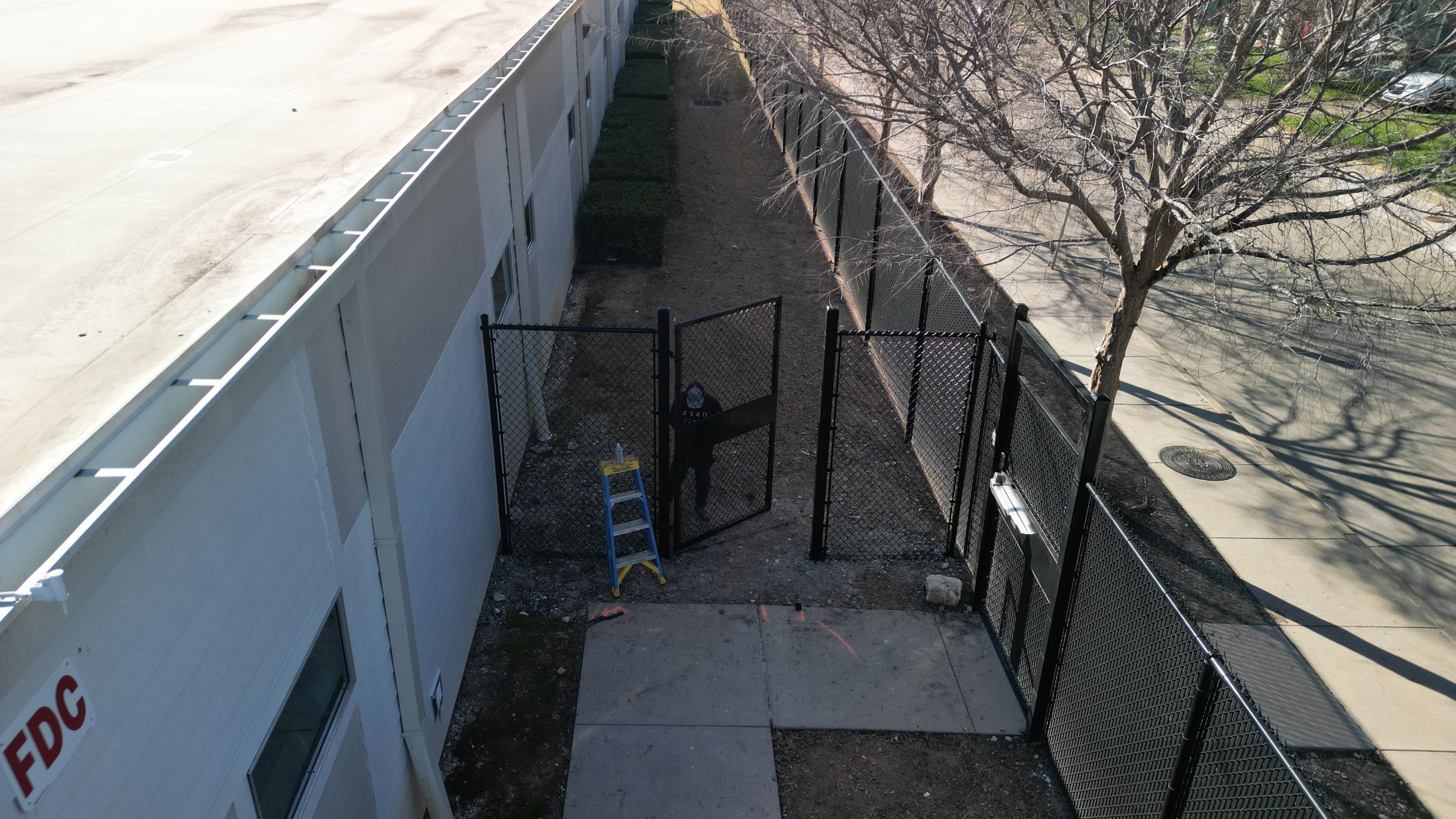 Commercial Fencing - Black vinyl coated Chain link Fence by 3:16 Roofing and Construction