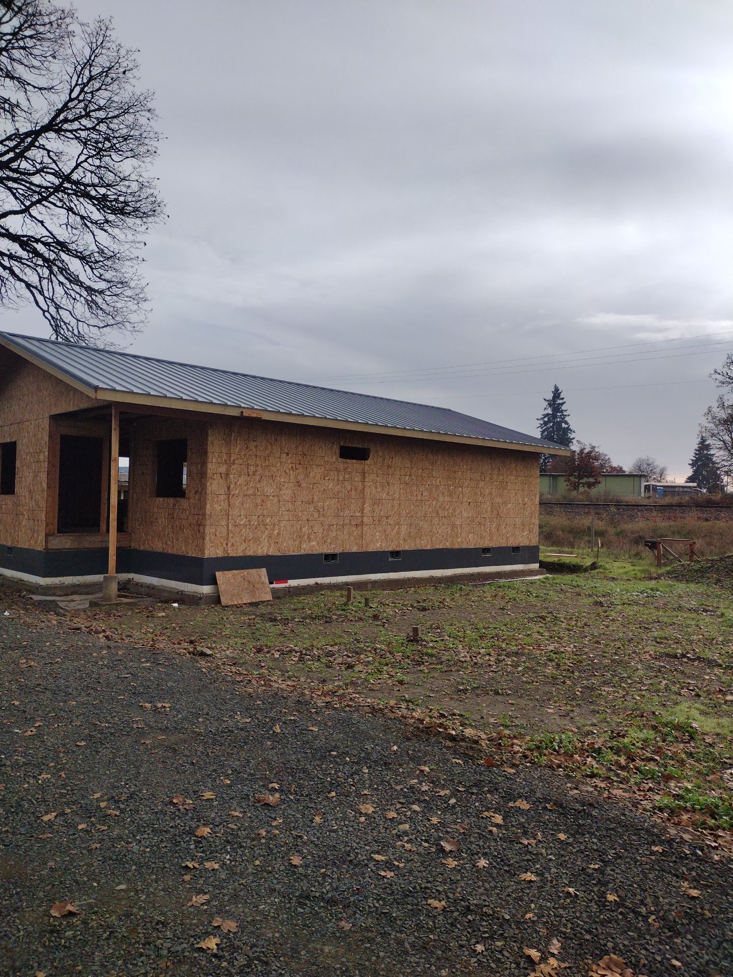 Grey Habitat for Humanity Metal Roof by Orezona Building & Roofing Company, Inc.