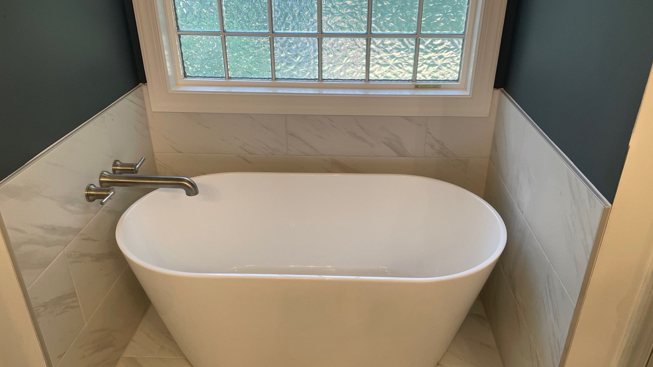 Bright Bathroom Remodel with Wall Removal, Stand Alone Tub and New Vanity by Footprints Floors of Coastal Carolina