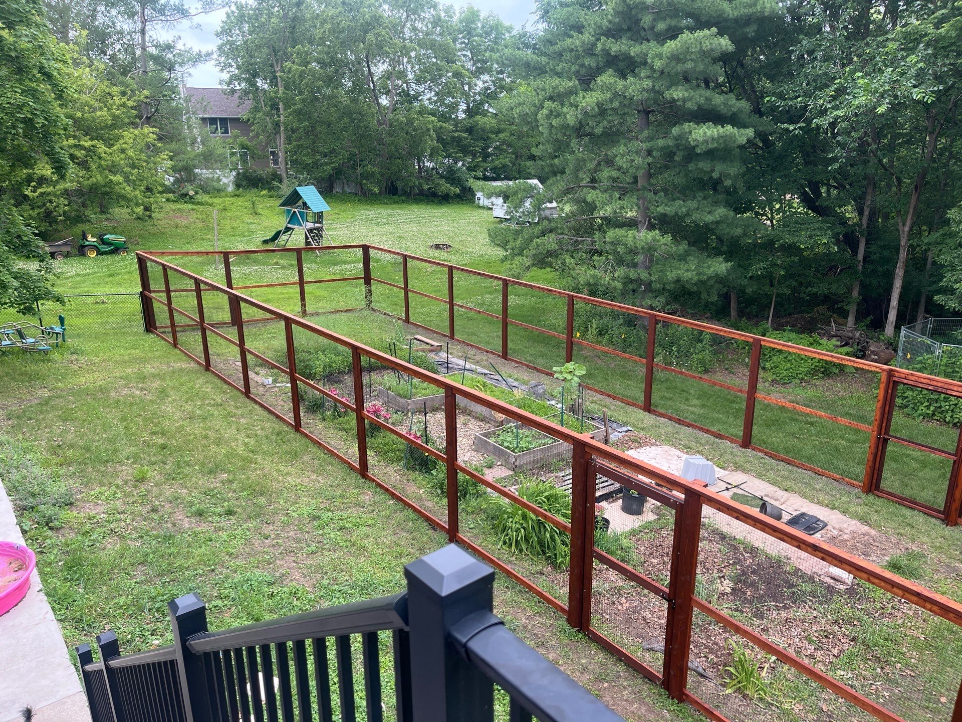 Stained Cedar Mahogany Garden Fence and Raised Bed Enclosure in Cedar Falls by Perfect Picket Fence and Stain